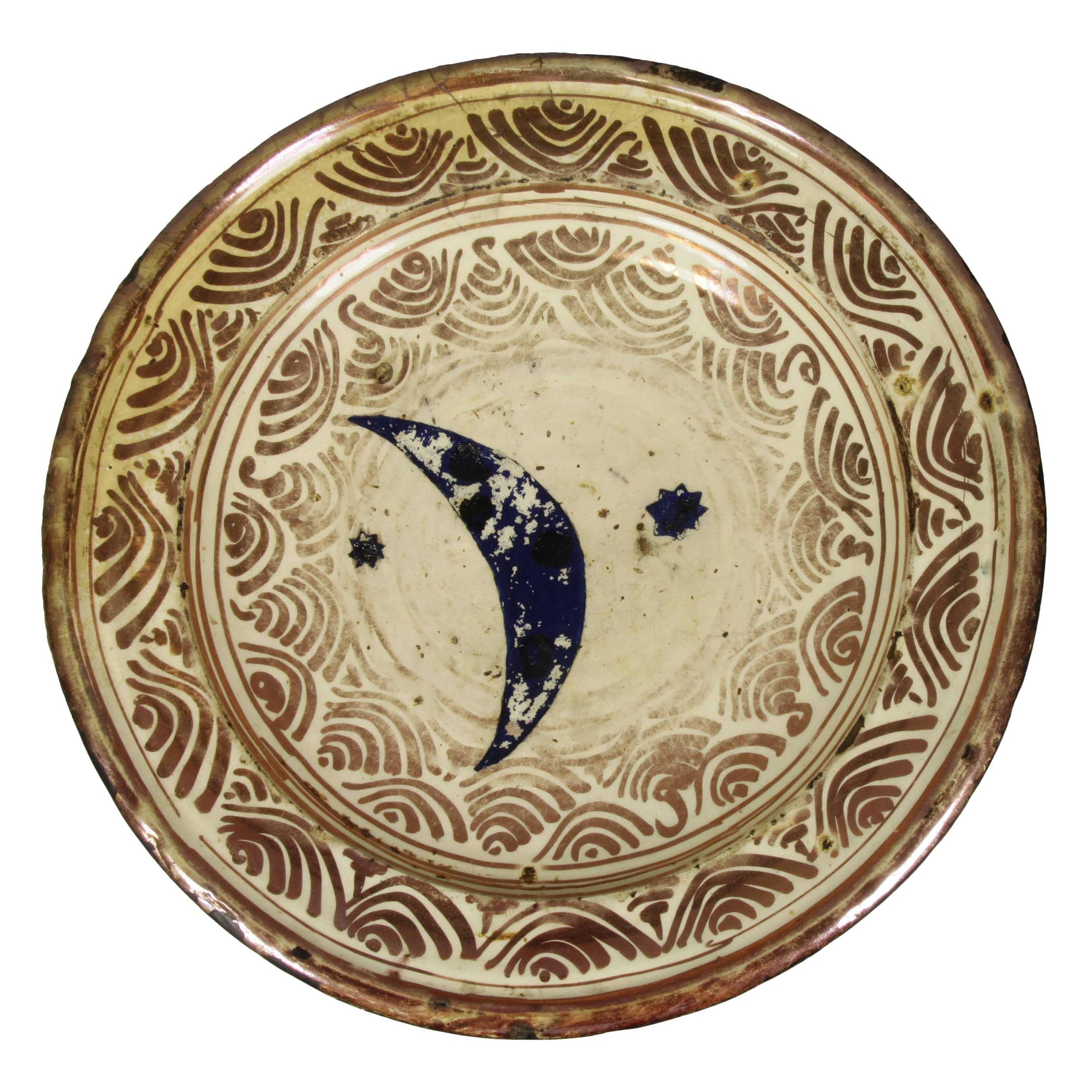 An Iberian tray that has a hand painted dark blue crescent moon and two stars in the middle.