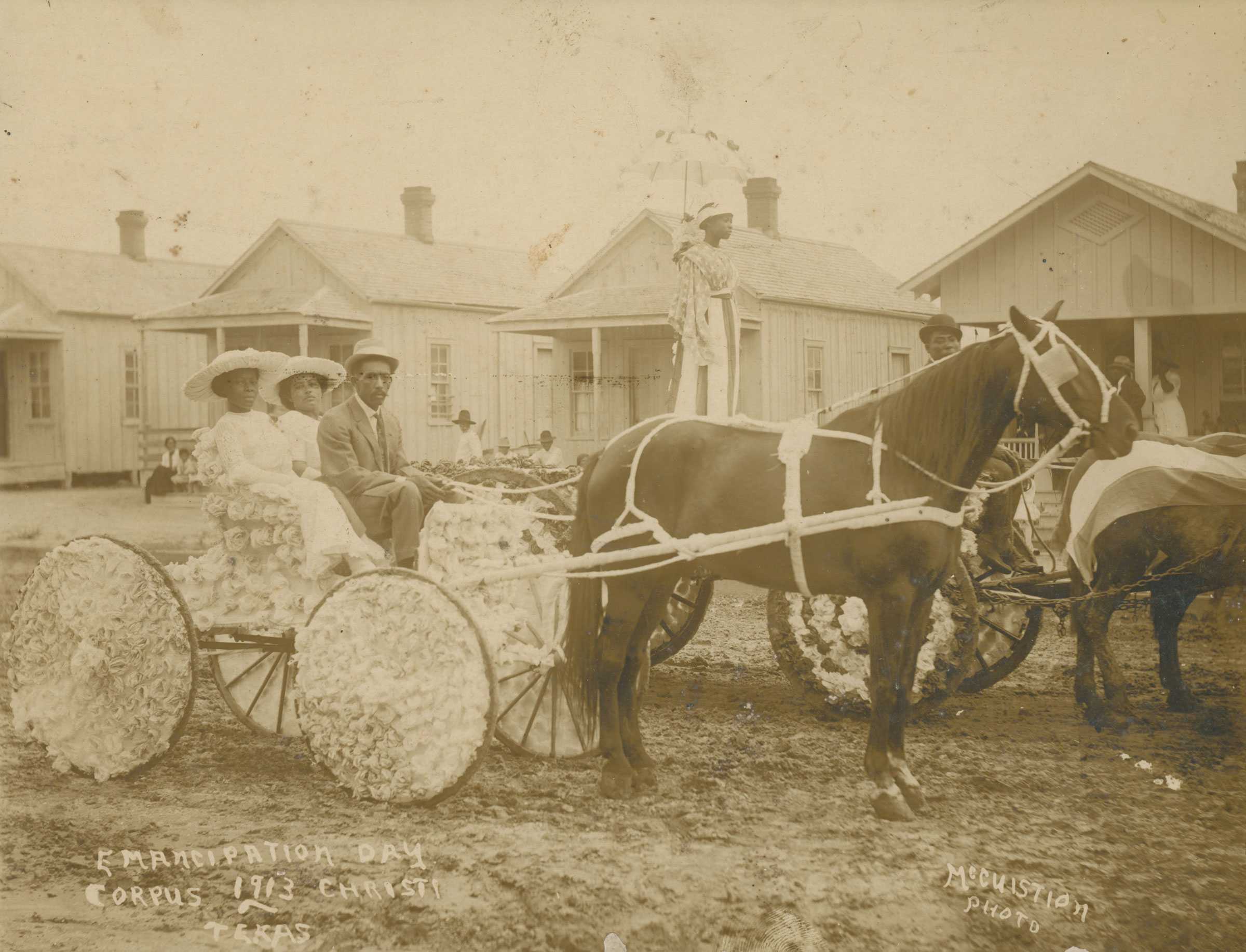People on a horse-drawn carriage decorated with flowers during Emancipation Day in Corpus Christi, Texas, 1913.