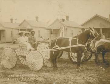 People on a horse-drawn carriage decorated with flowers during Emancipation Day in Corpus Christi, Texas, 1913.