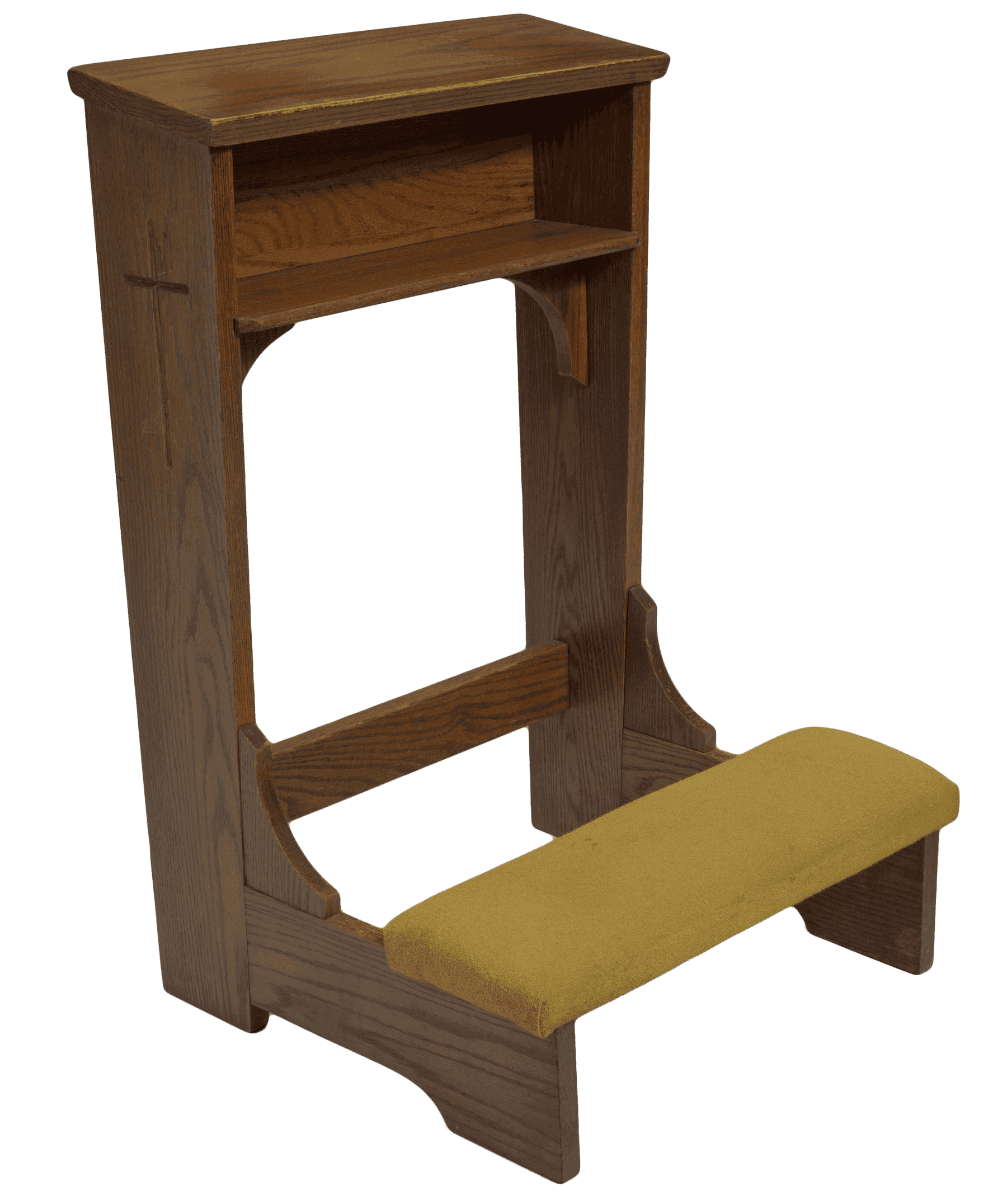 A wood kneeling altar with a yellow-green padded knee rest. The altar has small cubbyhole under the top shelf. The shelf is slightly tilted down toward the knee pads. The bottom of the shelf and cubbyhole are supported by two curved arches on either side, attached to the side planks. On either side of the altar at the top of the side planks is a carved cross. A small rectangular support board is near the base of the altar and connects the two side planks. Kneepads are attached to the fixed base with two solid horizontal planks on either side. A small, wood, inverted arch support connects the knee rest to the vertical side planks.