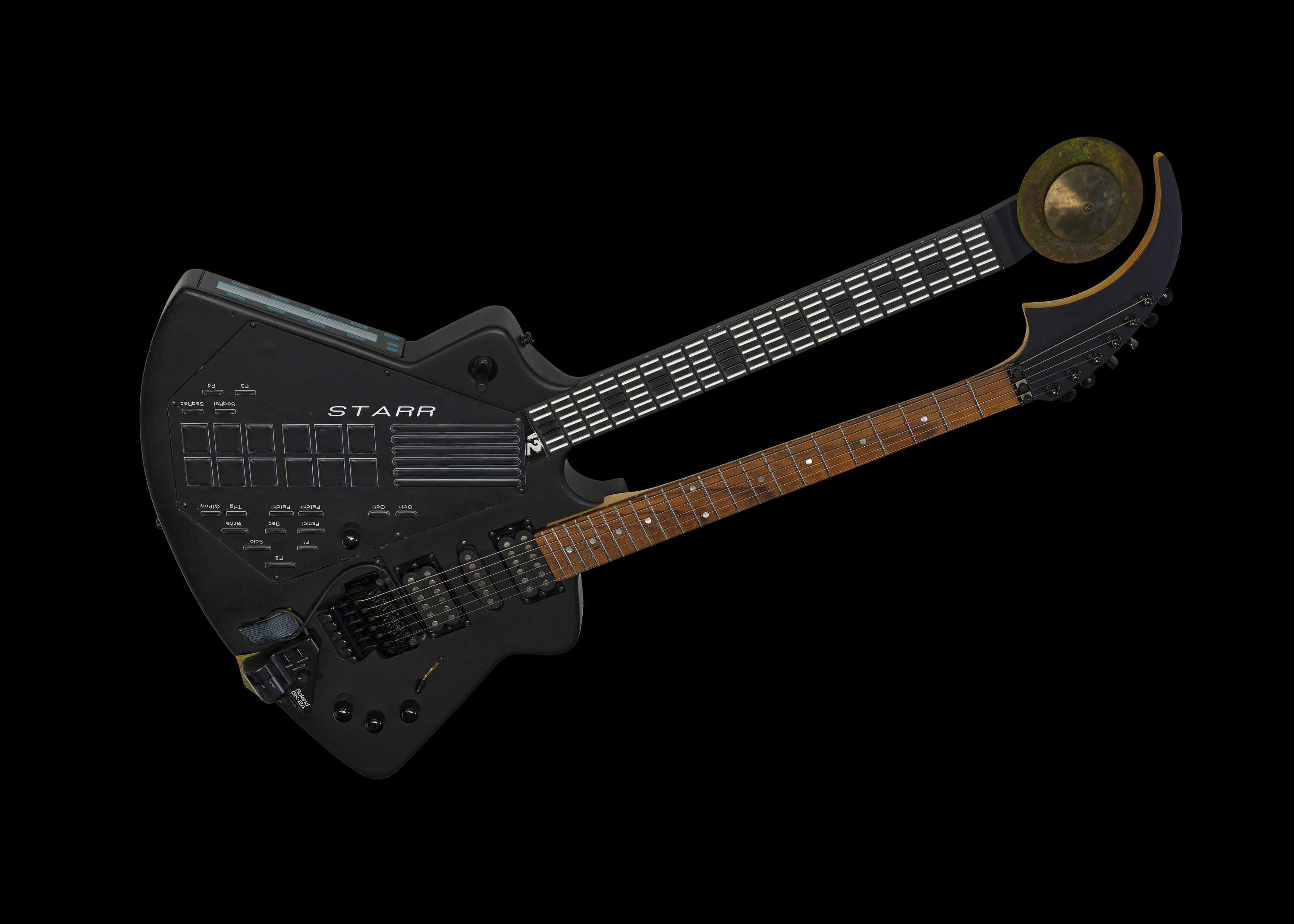 The double guitar synth has two frettboards and a conjoined body.