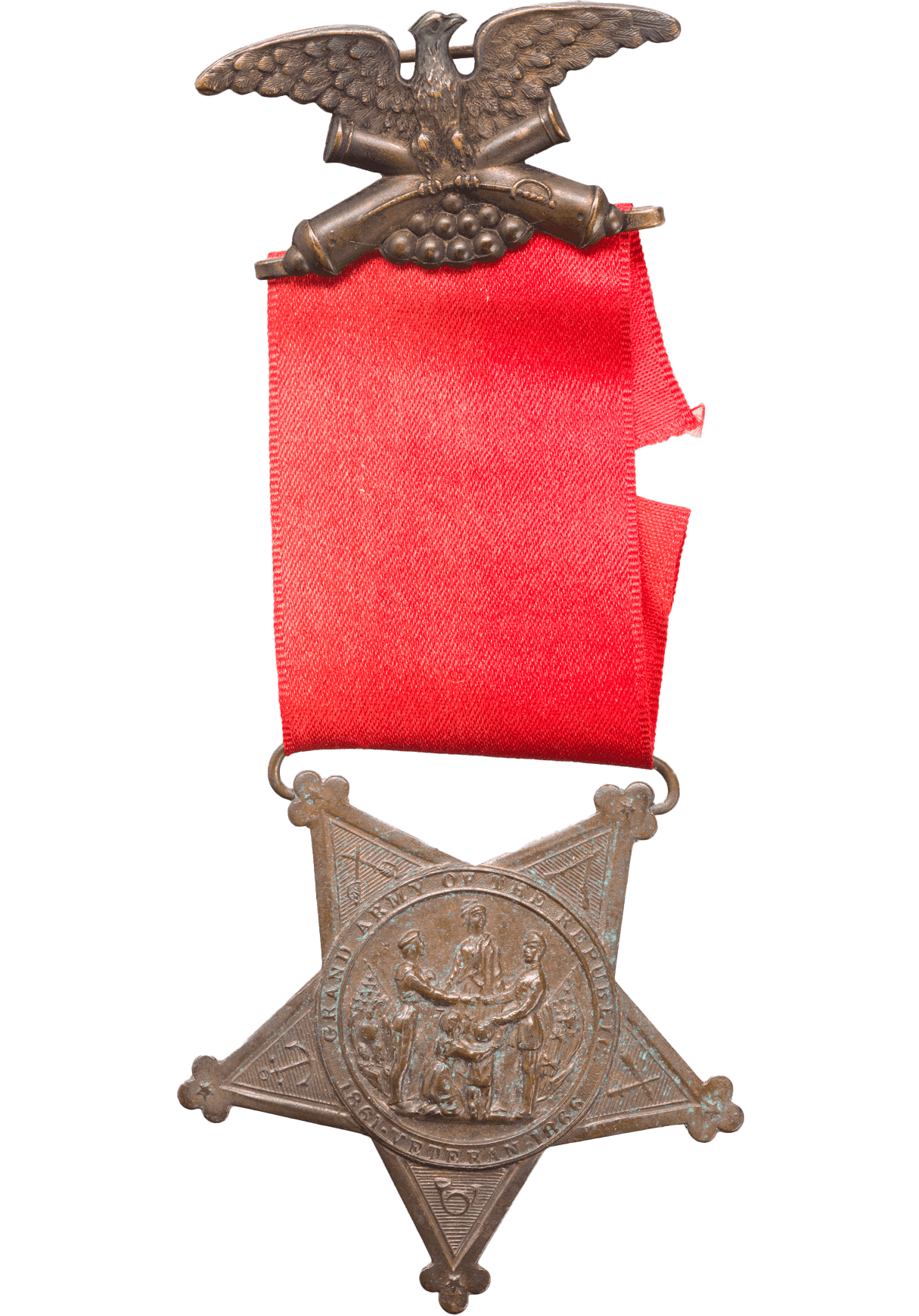 A Grand Army of the Republic medal owned by Marquis Peterson. The medal has a suspension brooch in the shape of an eagle with spread wings above crossed canons. It is attached to a red ribbon. A metal suspender attaches the medal to the ribbon. The medal is in the shape of a five-pointed star. The front of the medal Has the seal of the Grand Army of the Republic at center. The seal shows a sailor and soldier next to American flags. They are shaking hands in front of a standing woman. A kneeling woman and a standing child with raised arms are between the sailor and soldier. Embossed lettering circles the seal around the edge and reads “GRAND ARMY OF THE REPUBLIC” at top and “1861 VETERAN 1866” at the bottom. Around the seal on each point of the star additional emblems are embossed. They are crossed sabers, crossed rifles, crossed cannons, a bugle and an anchor. The back of the medal has a shield at center. This is surrounded by 8 fraternal symbols forming a circle. This circle is surrounded by another circle of 16 fraternal symbols. This is encircled by 34 five-pointed stars. The five-star points on the back of the medal also have things embossed on them. The top two connecting to the suspender ae olive branches. The tow on the side are wreaths and the point on the bottom is of a banner.