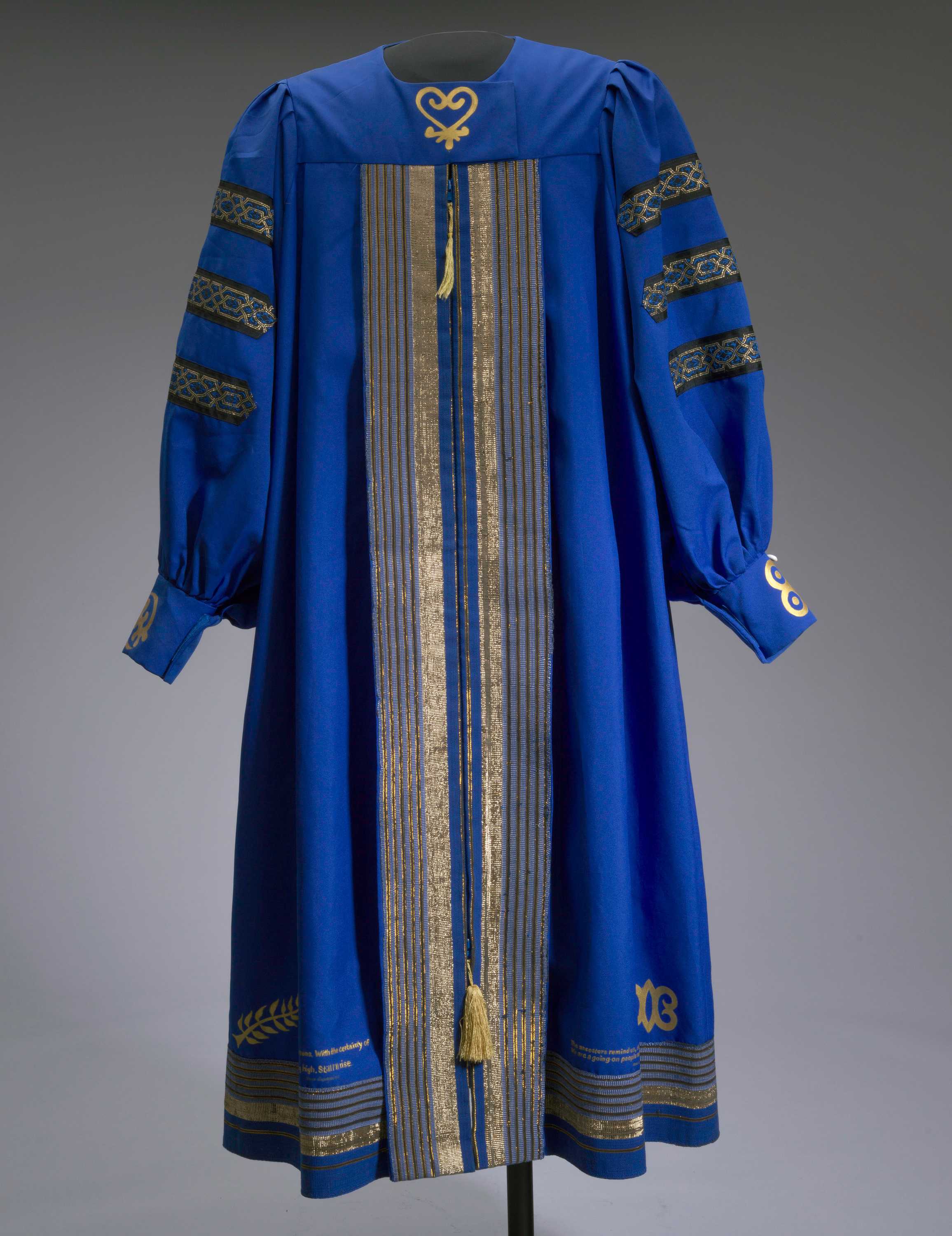 An academic robe in blue and gold from Bennett College worn by Dr. Johnnetta Betsch Cole with custom designs by Barbara Nicholson.