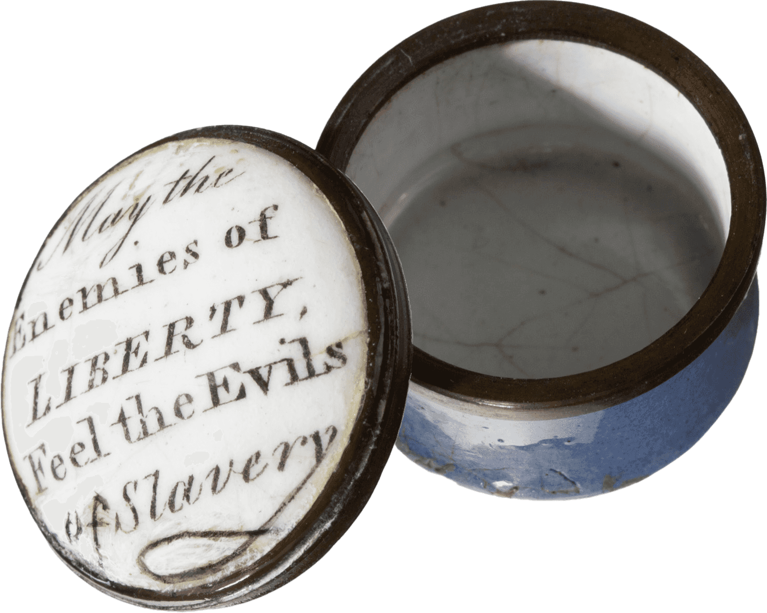 A round, blue, white and black enamel container with a removable lid. The lid of the container is white. Written in black script on the lid of the container is "May the Enemies of LIBERTY, Feel the Evils of Slavery." The outside of the container is light blue, with a black rim. The inside is white.