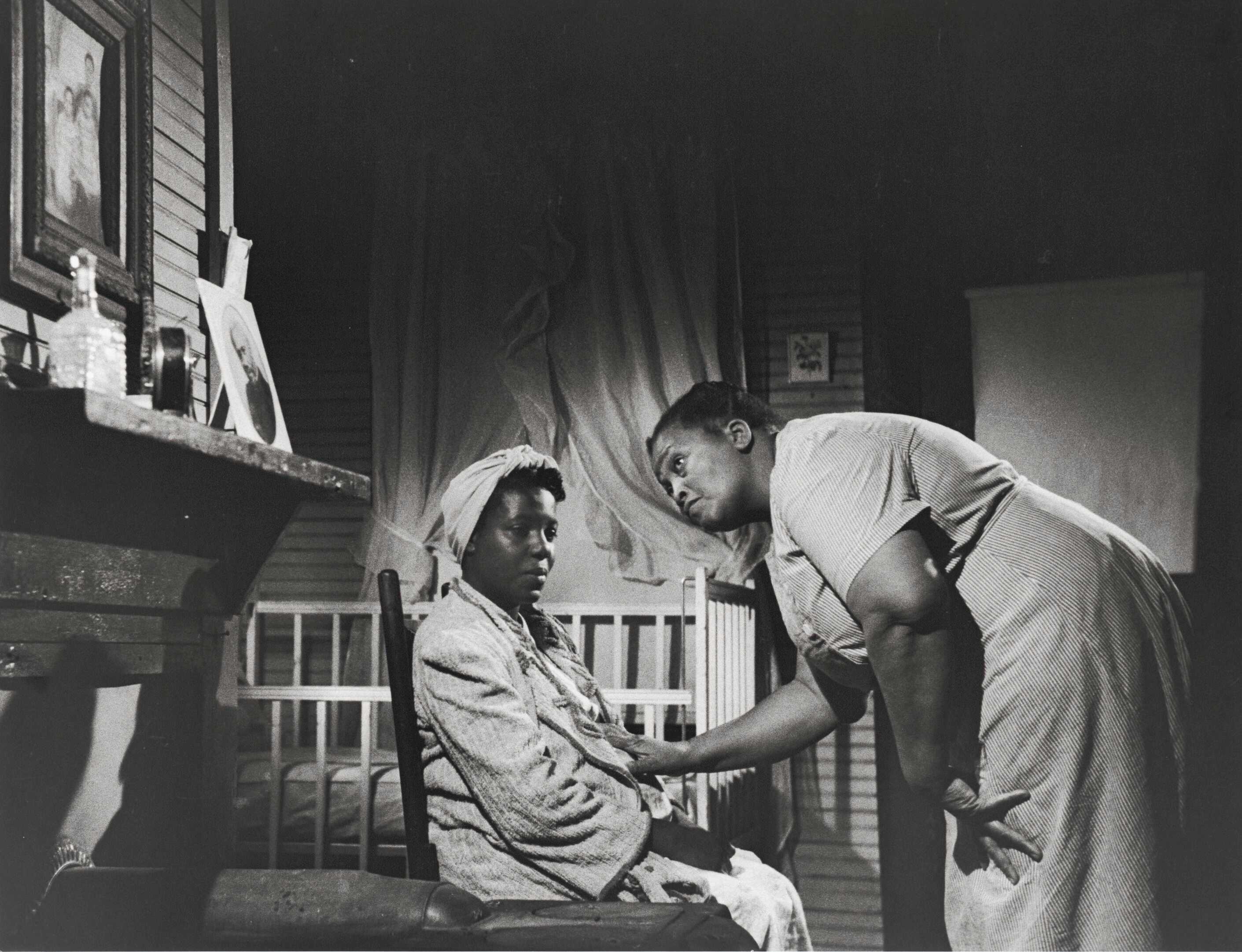 Black and white image of two (2) women, Mary Francis Hill Coley and Martha Butler Sapp in an interior room of a house.