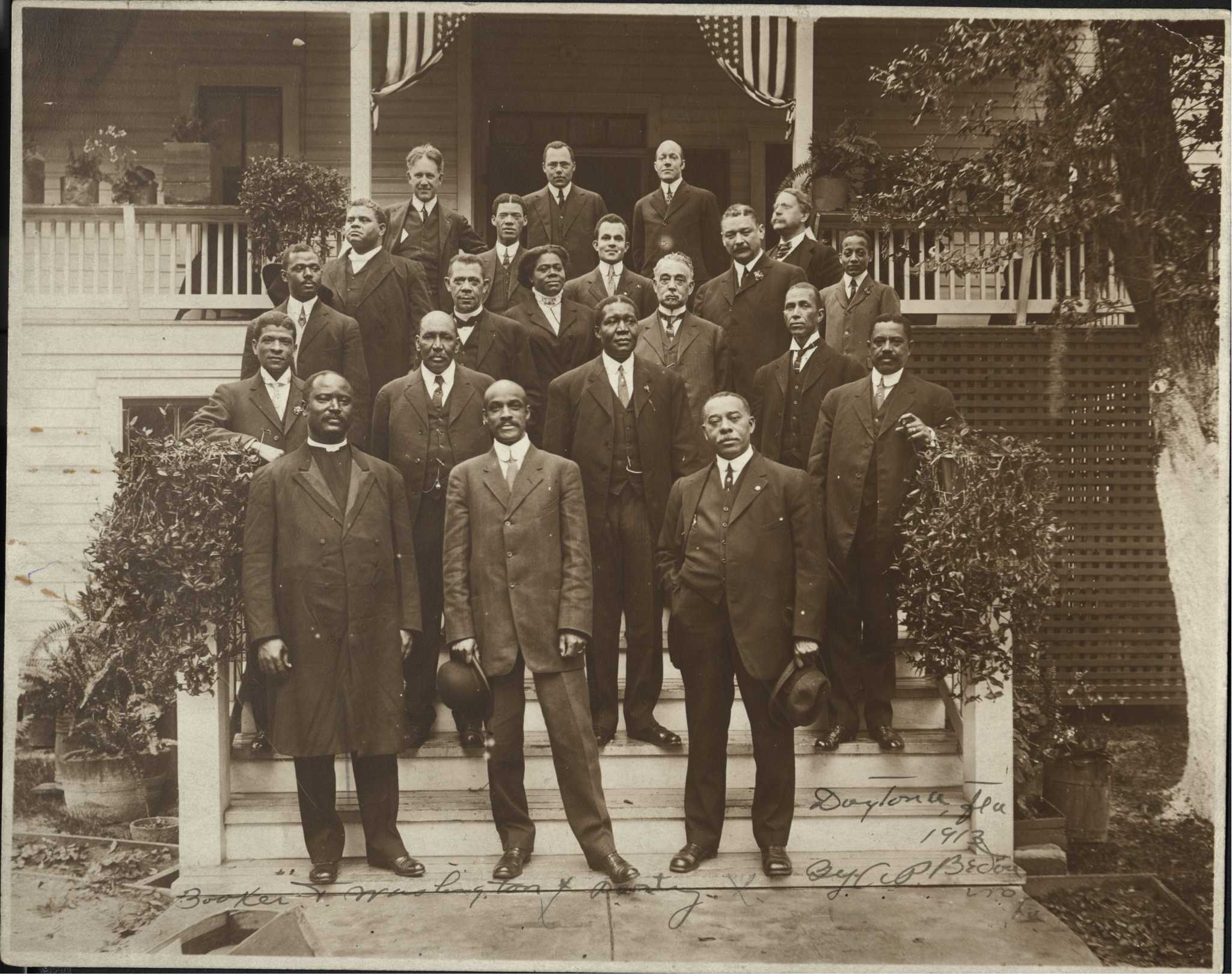 Photograph of Mary McLeod Bethune with Booker T. Washington (third row, second from left) during a visit to Daytona Institute