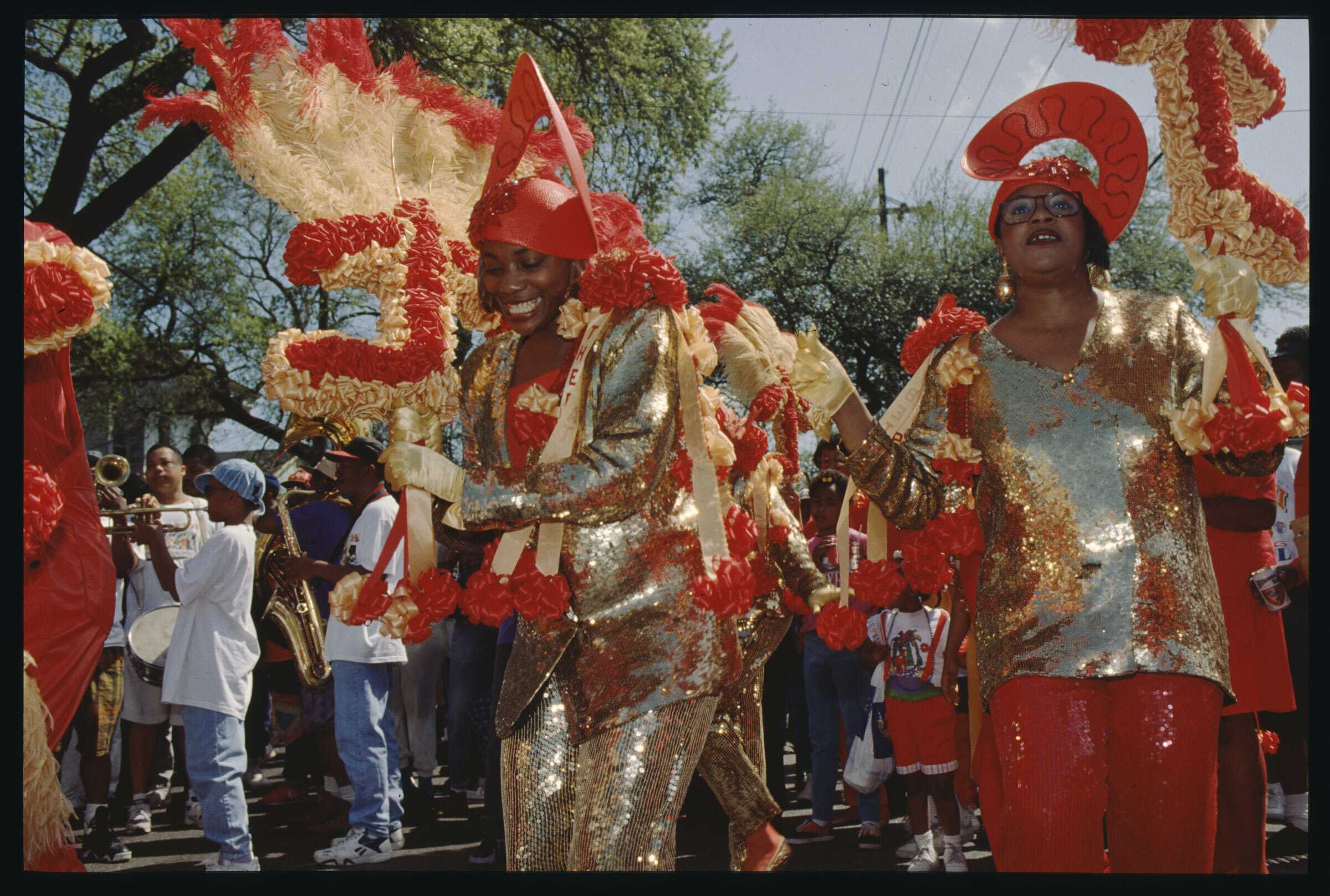 Color photograph of brightly dressed women in a marching band.