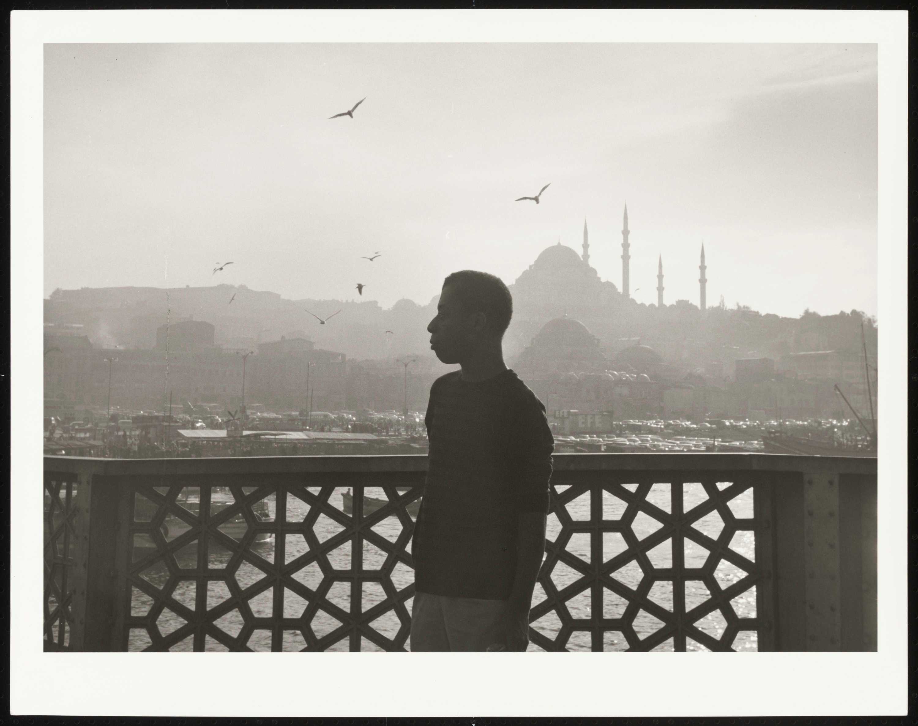Image of a photograph of James Baldwin on the Galata Bridge in Istanbul, Turkey, 1966.