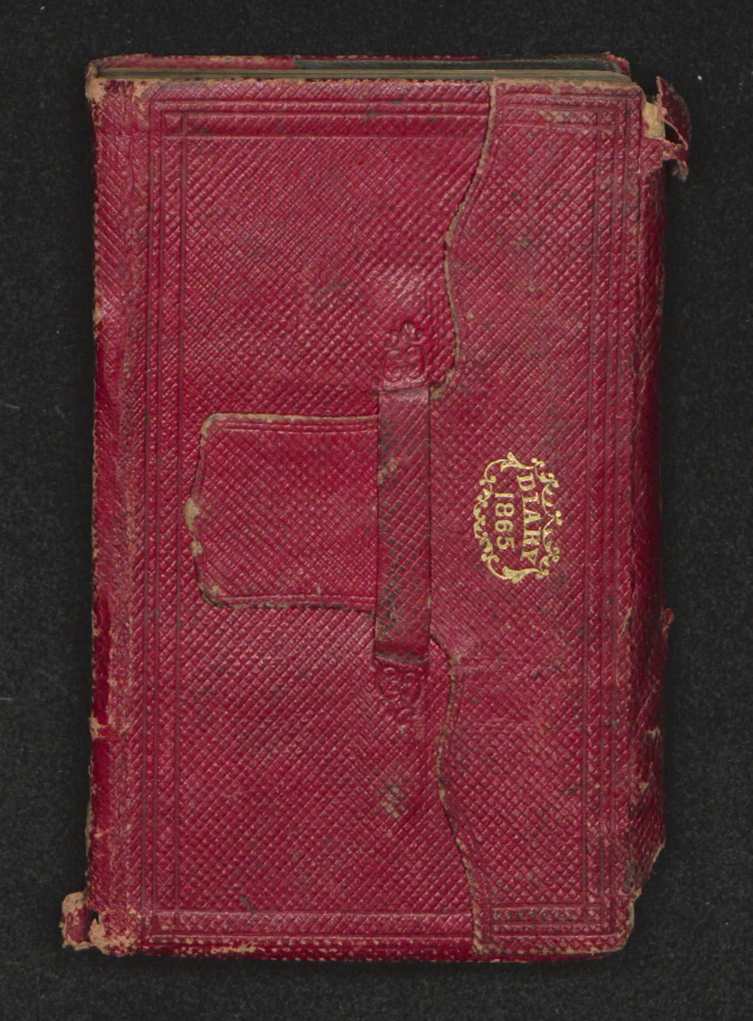 A handwritten diary encased in a red leather cover with "Diary / 1865" embossed in gold lettering at top center surrounded by an ornate wreath. The diary is inscribed on the front endpaper in both pencil and ink. The diary begins with several printed pages including a page outlining eclipses that occurred in 1865, a calendar, a table of stamp duties and rates of postage.  The diary entries were done predominantly in pencil. The diary begins on January 1, 1865 with the last entry occurring on September 30, 1865. The diary ends with a memorandum section and an accounts paid section. Both of these sections were used by Lieutenant John Freeman Shorter. A back pocket in the back of the diary contains two loose sheets of paper. One of the pieces of paper is a promotion certification for a second lieutenant in the 55th Massachusetts volunteer regiment. The document is written in ink.  It is dated April 19, 1865. Additional notes are written in pencil on the other side of the document. The second piece of paper has a list of people’s names, dollar amounts and dates written on both sides in both ink and pencil.