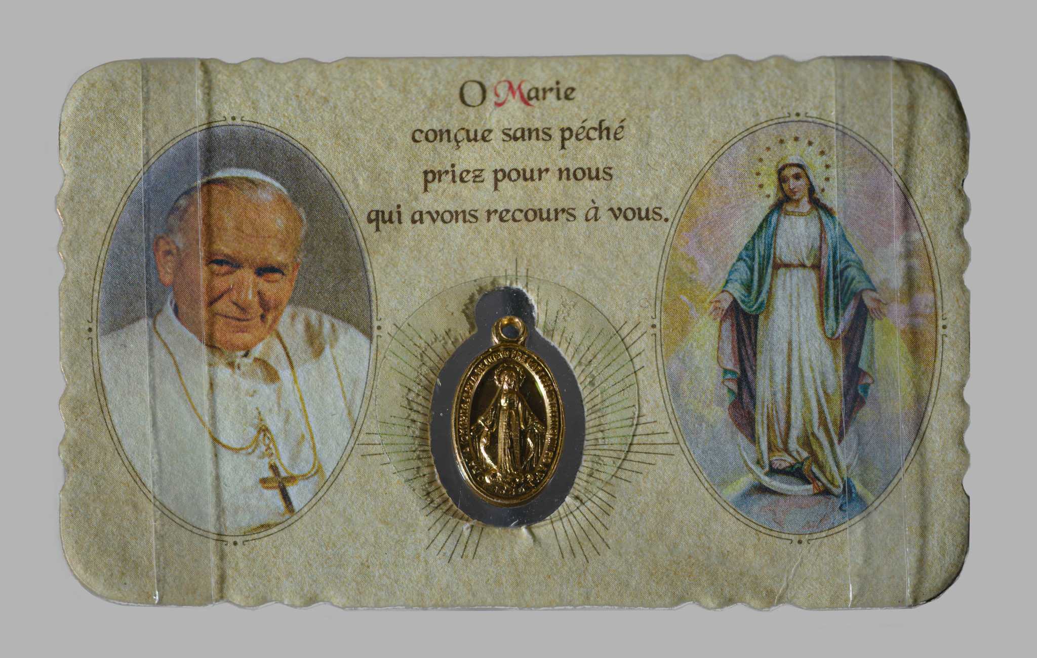 Photograph of Italian Miraculous Medal on paper with religious imagery