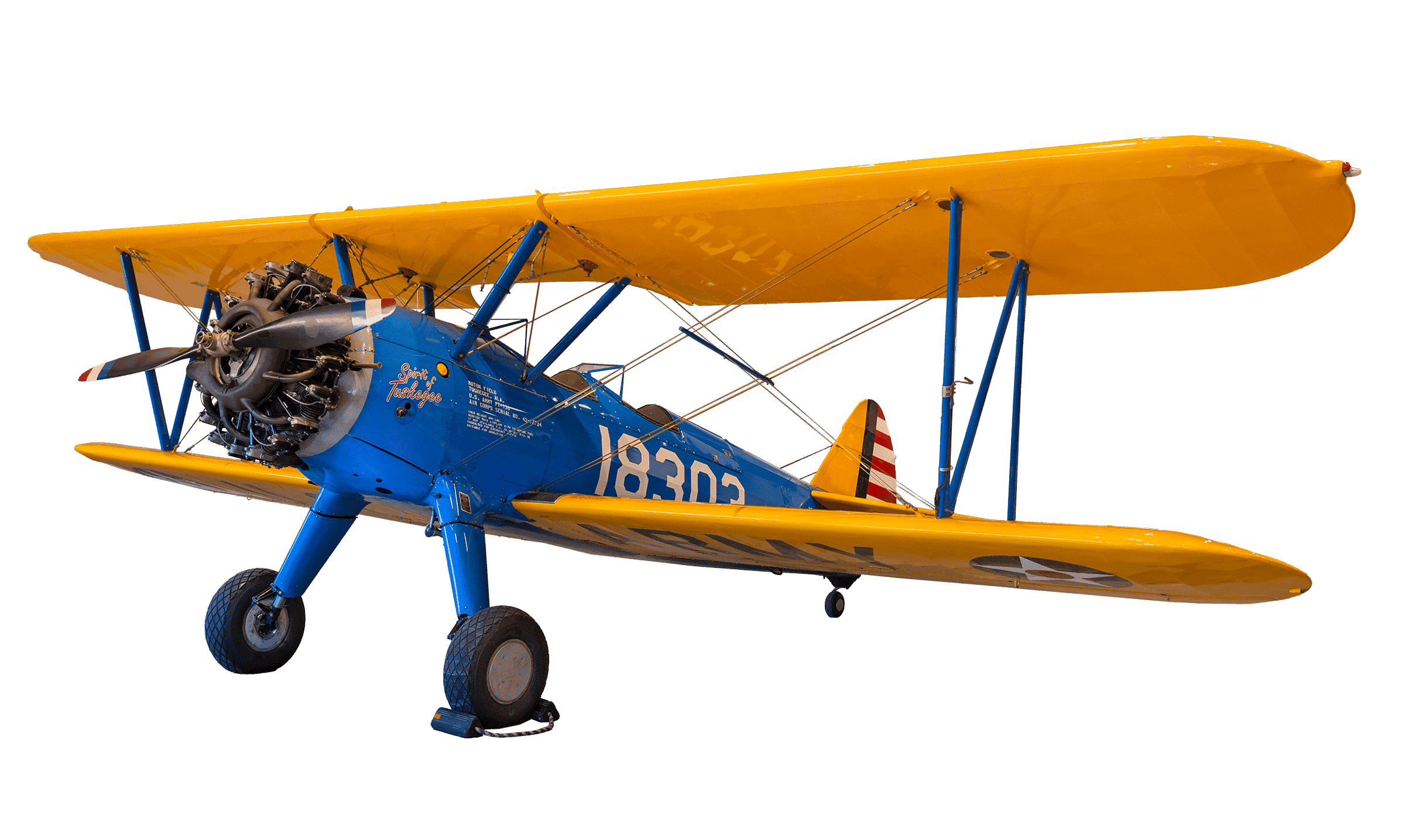 The PT-13D Stearman Kaydet has a blue body, yellow wings, and "Spirit of Tuskegee" in red on the cowl.