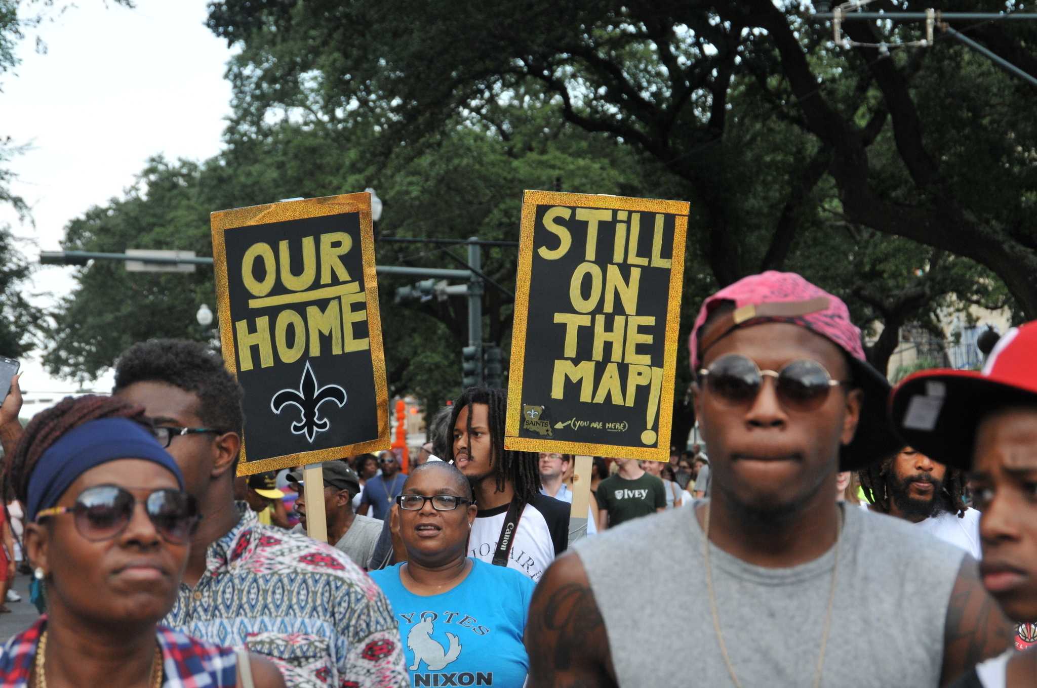 A second line snakes through New Orleans following a healing ceremony, in the Lower 9th Ward