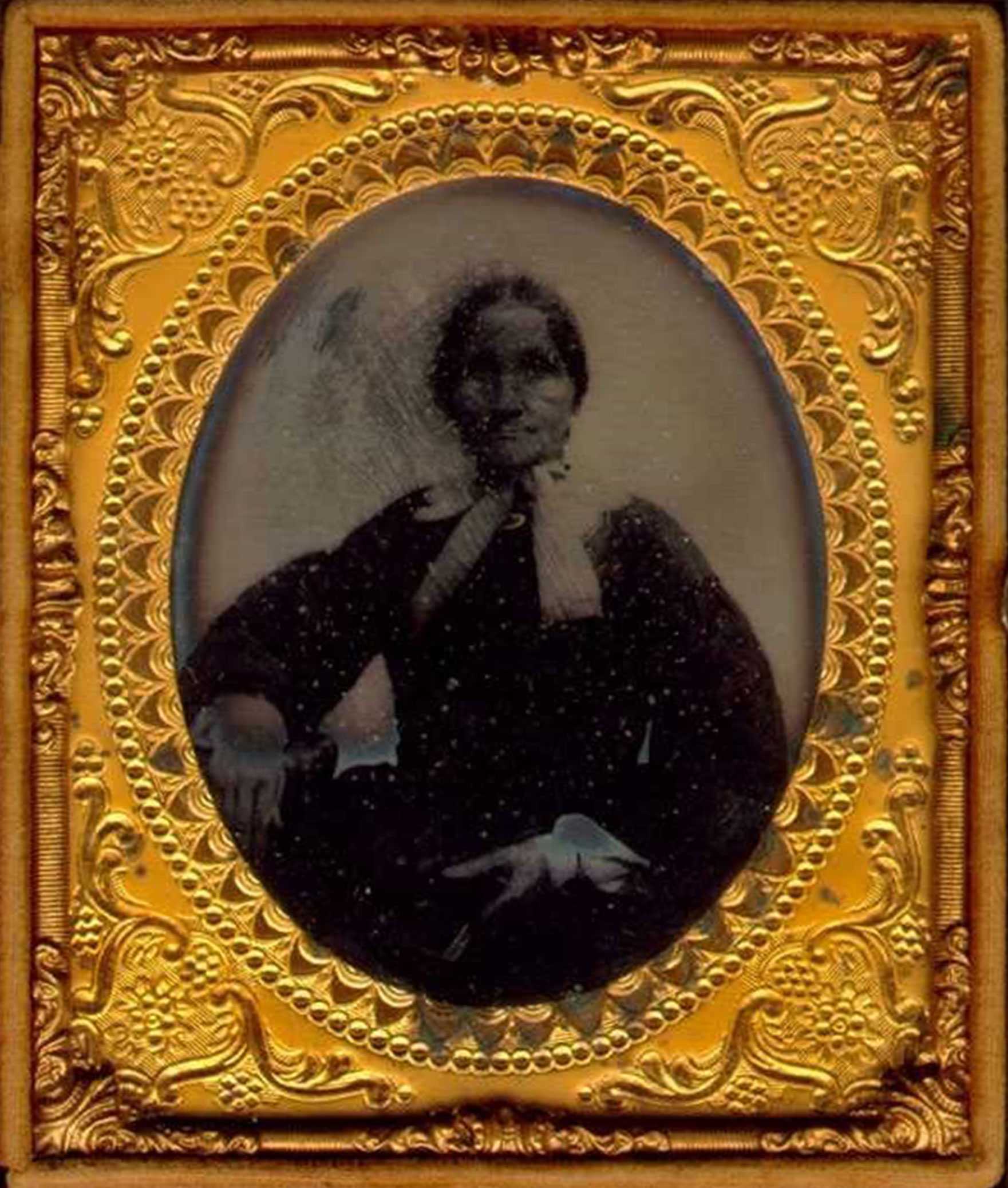 Framed daguerreotype of a seated person.