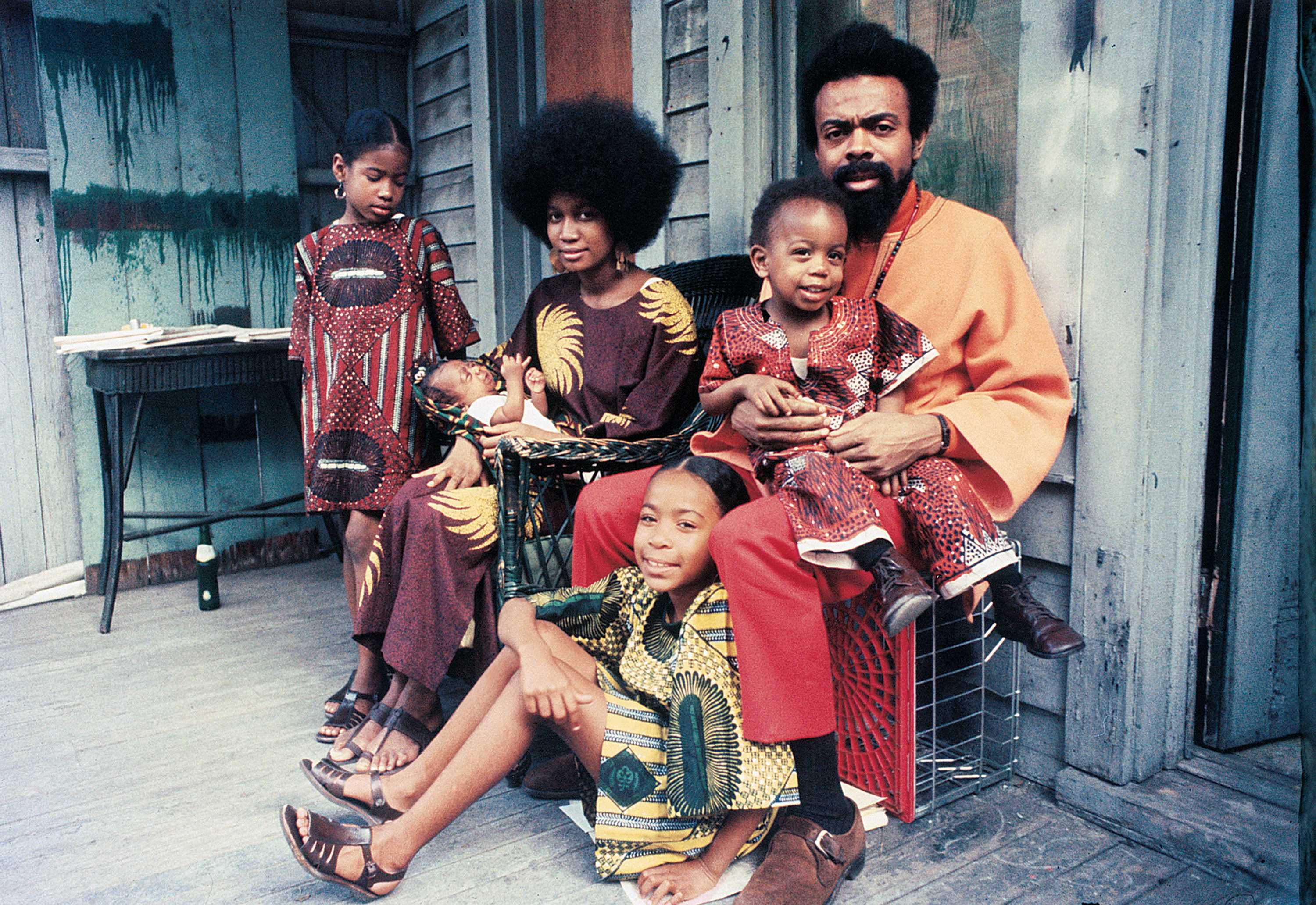 Color photograph of Amiri and Amina Baraka sitting in their home with their children