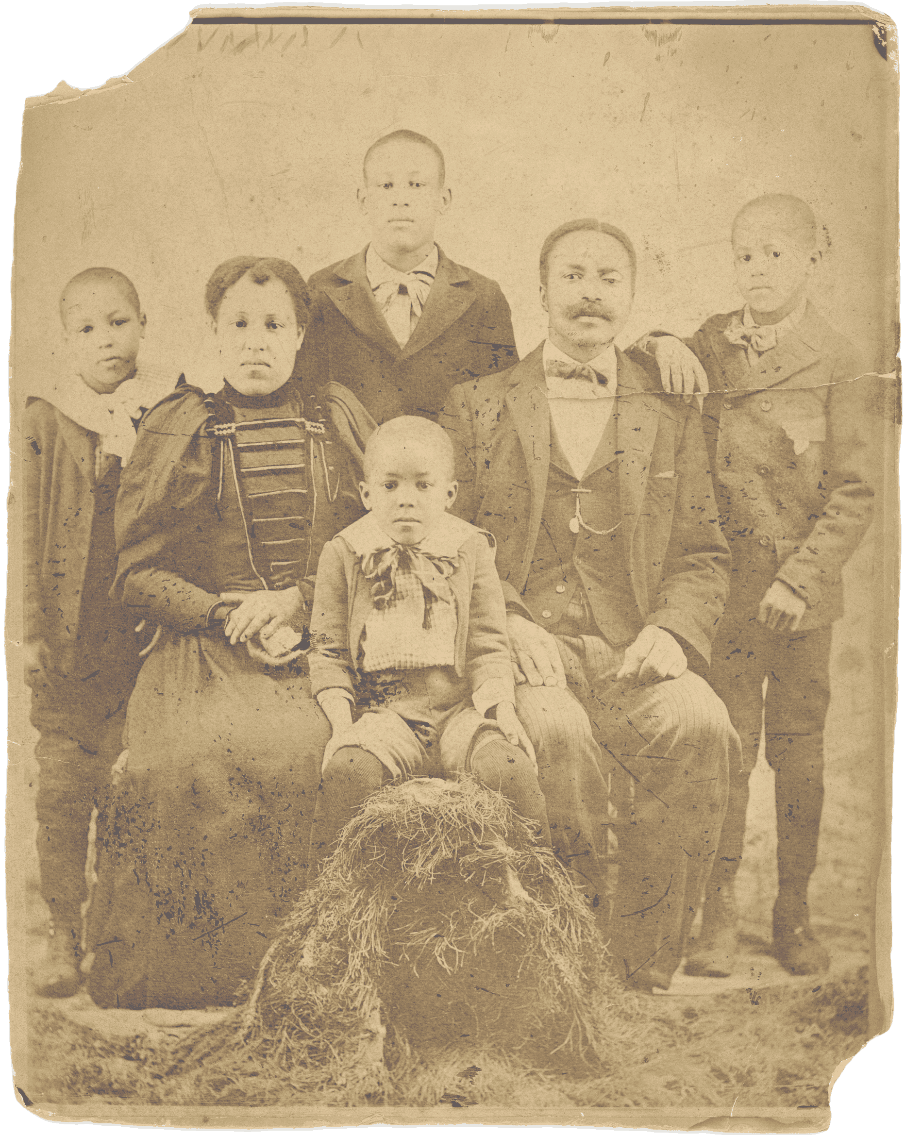 A sepia tone group portrait of a family with the two parents and 4 sons. They are looking at the camera.