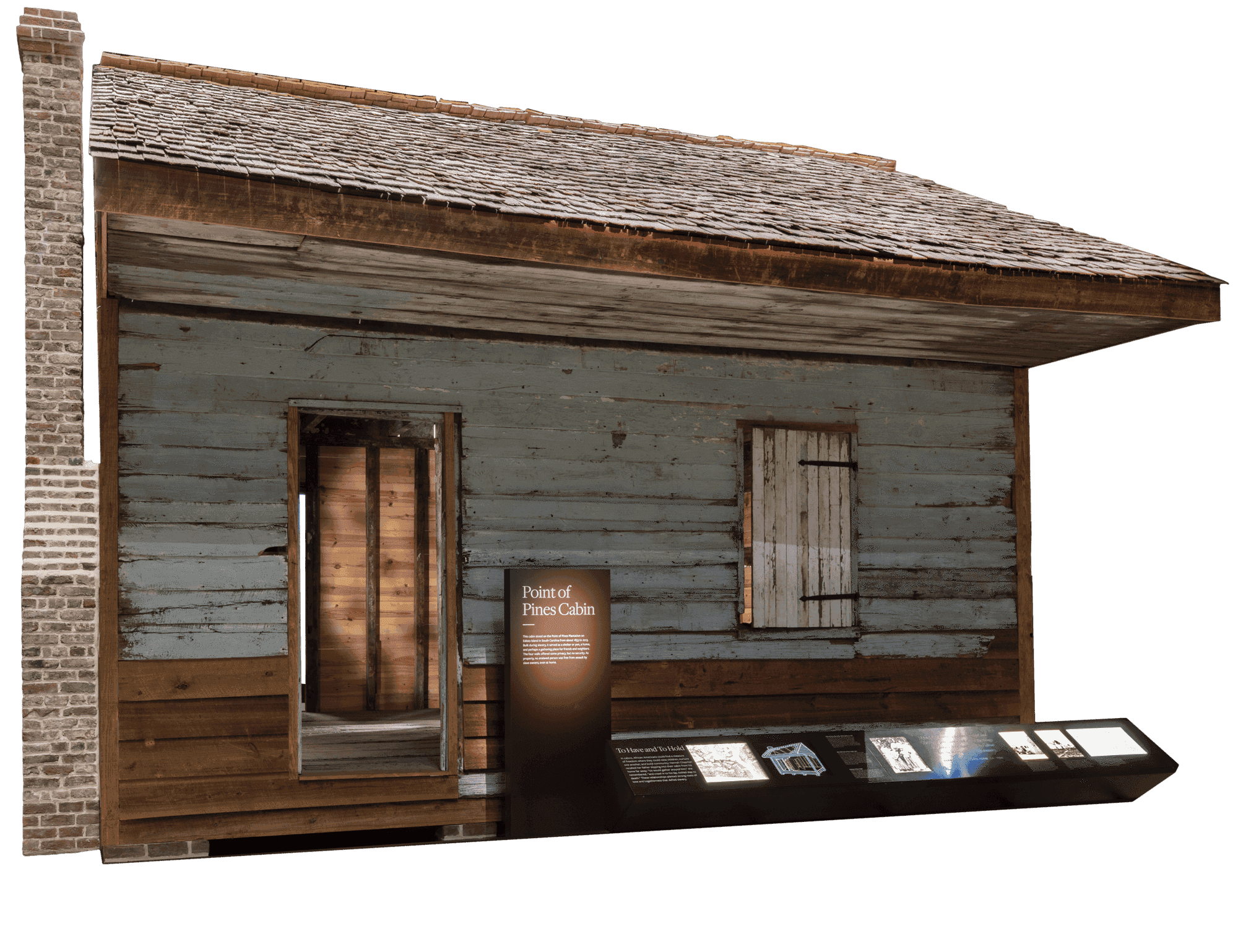 Within the museum, a full view of the Point of Pines Cabin, which has worn sides and roof.
