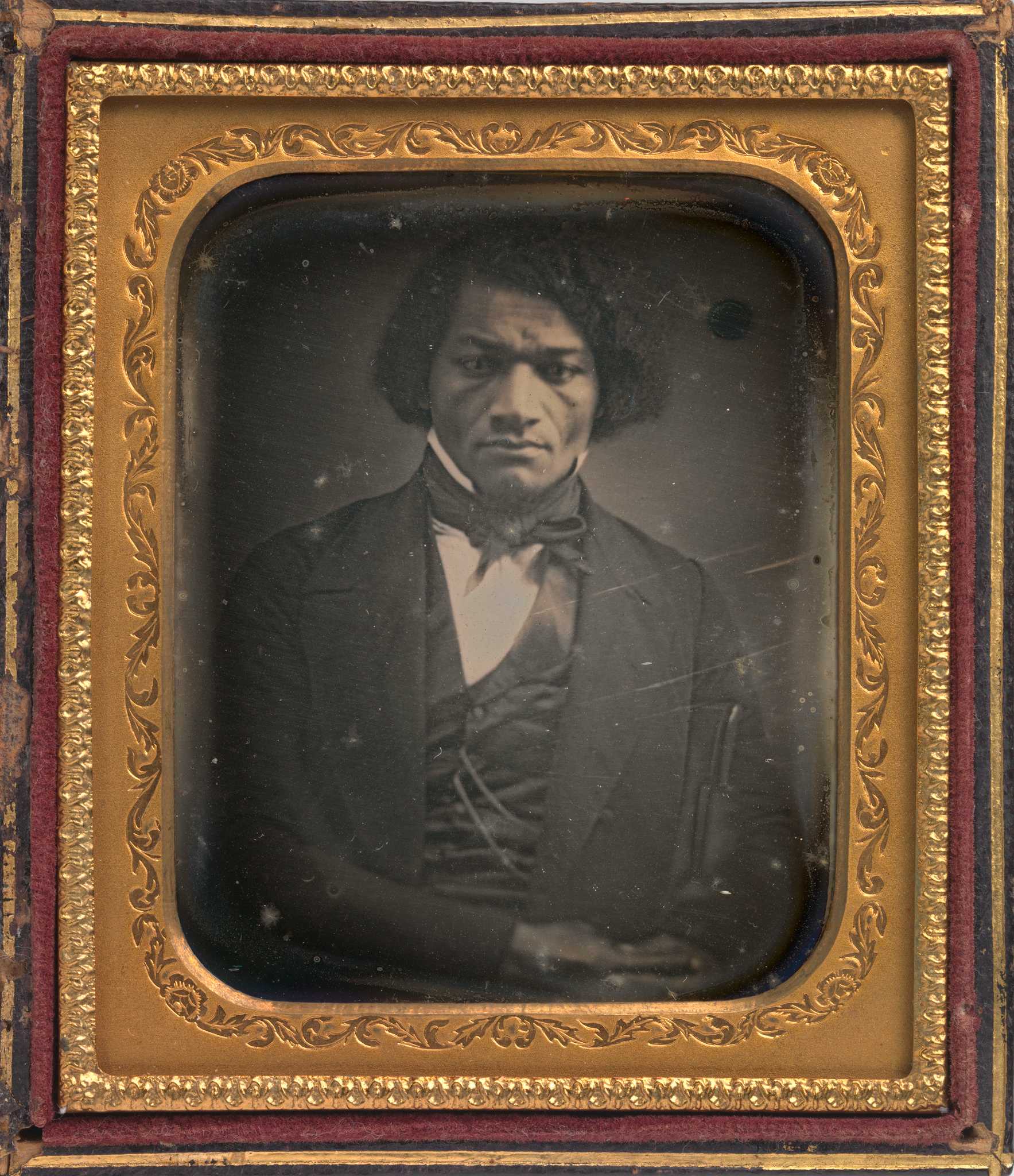 Photograph of Frederick Douglass in a gold frame