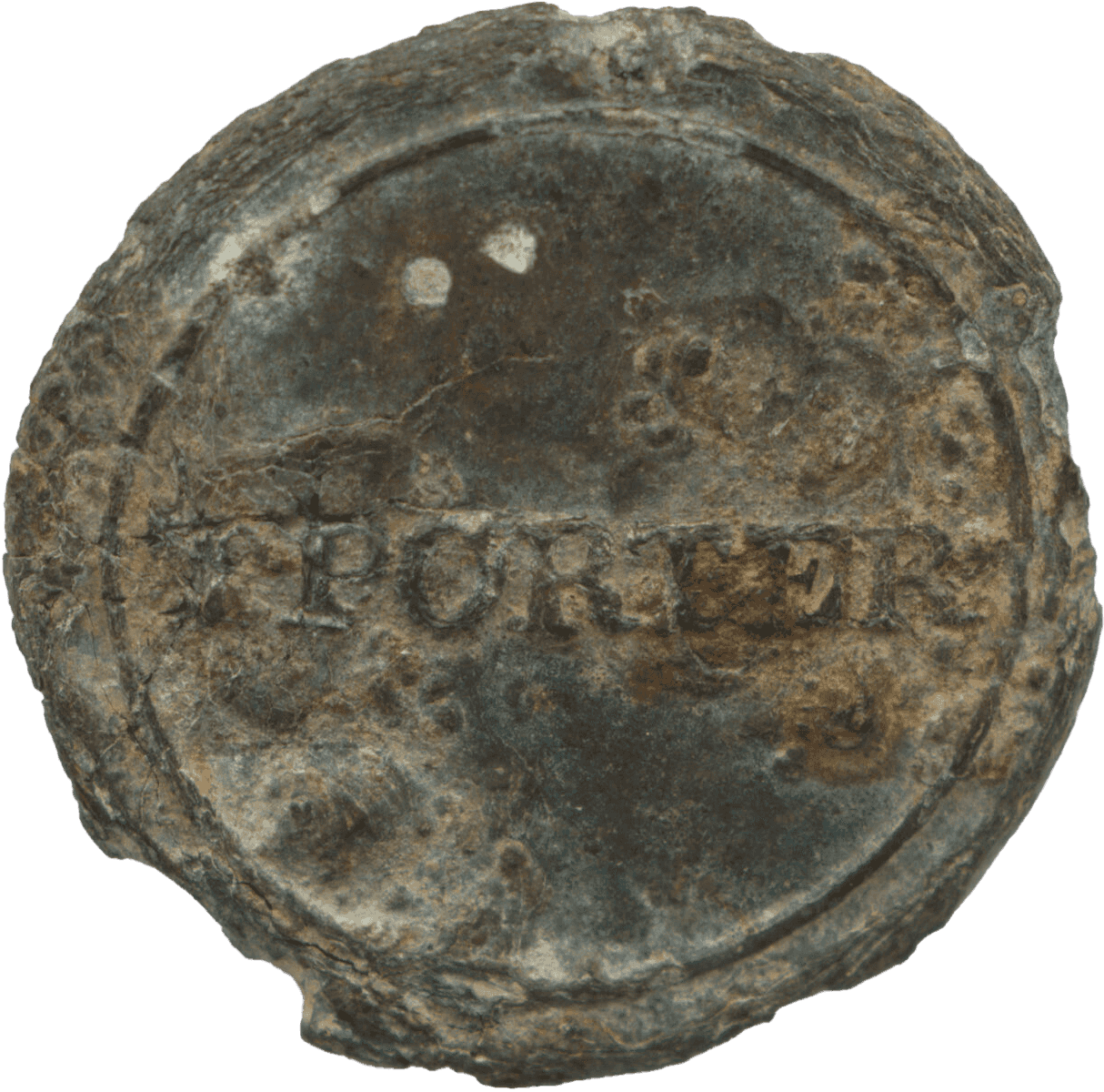 A round pewter button with "TPORTER" stamped across the middle. This button would have been sewn onto an enslaved person's shirt to identify him or her as belonging to Thomas Porter II. On the reverse side of the button there are fine concentric circle impressions within a pronounced rim as well as a stamp which is now illegible. There is also evidence of a parting line for a two-part mold on the reverse of the button. The button has considerable wear with pitting on both sides.