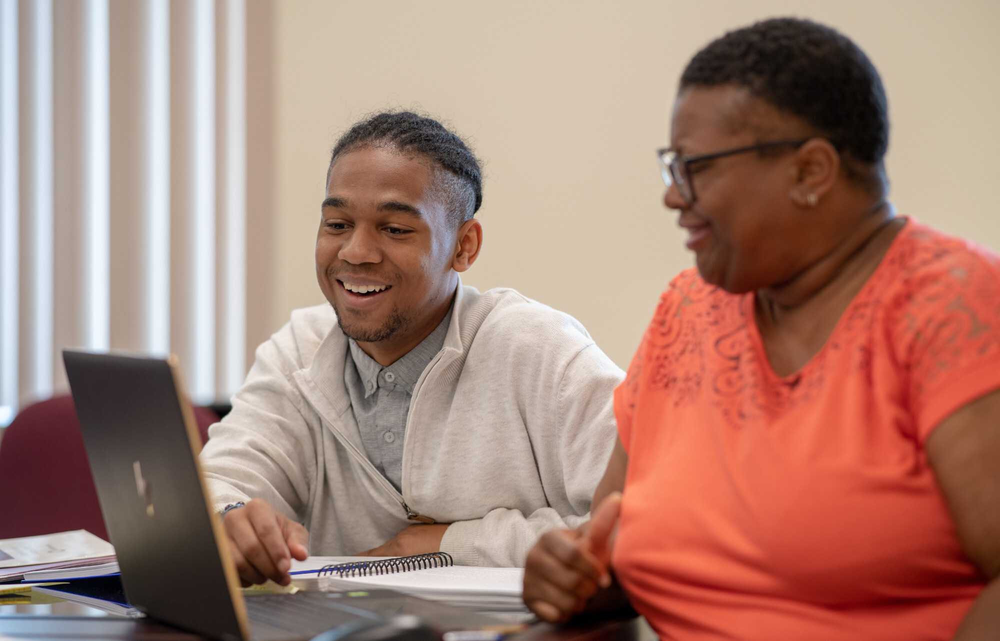 Photograph of two interns working on oral history project at a desk