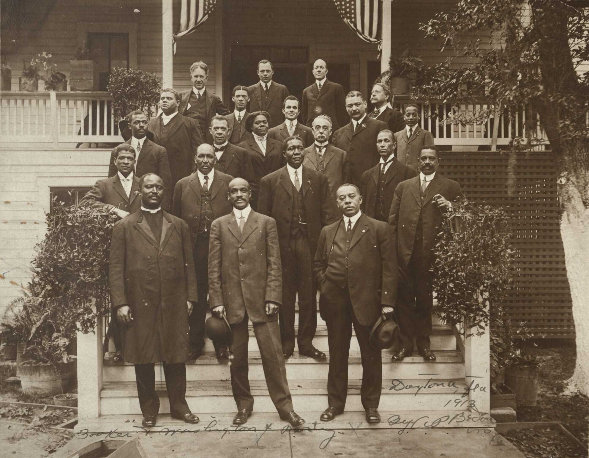 Photograph of Mary McLeod Bethune with Booker T. Washington (third row, second from left) during a visit to Daytona Institute