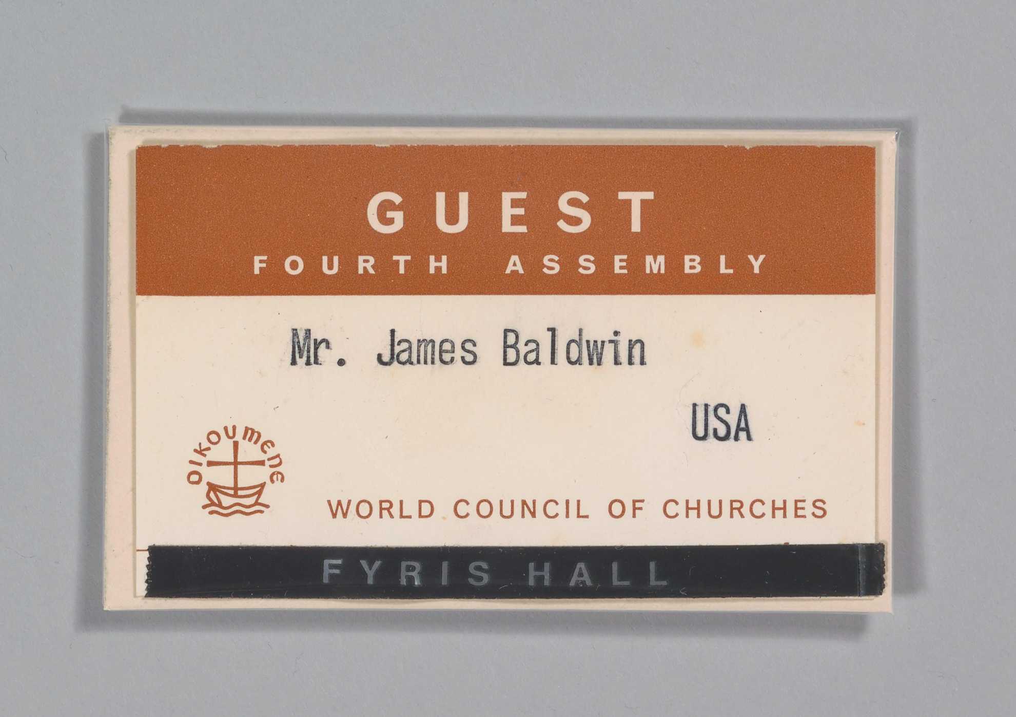 A guest badge for the 1968 World Council of Churches Fourth Assembly. James Baldwin's name is typed on the badge.
