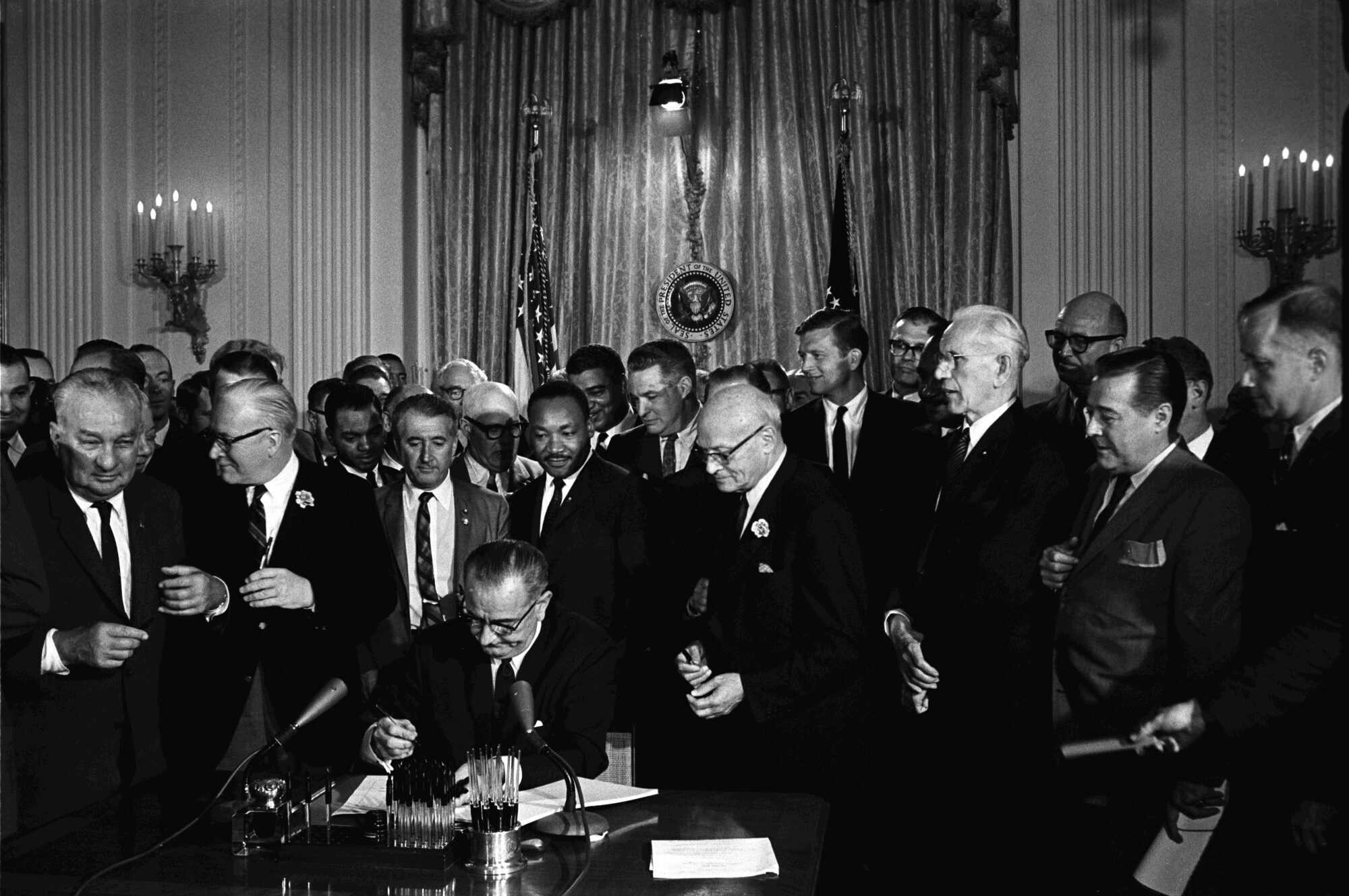 President Lyndon B. Johnson signs the 1964 Civil Rights Act