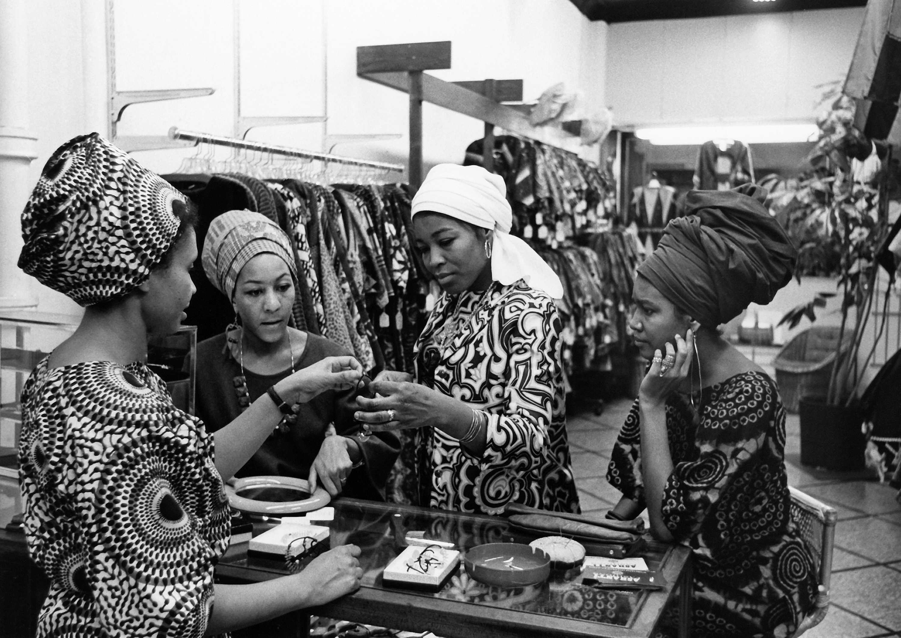 Black and white photograph of Betty Shabazz shopping with Evelyn Neal and Amina Baraka at a boutique