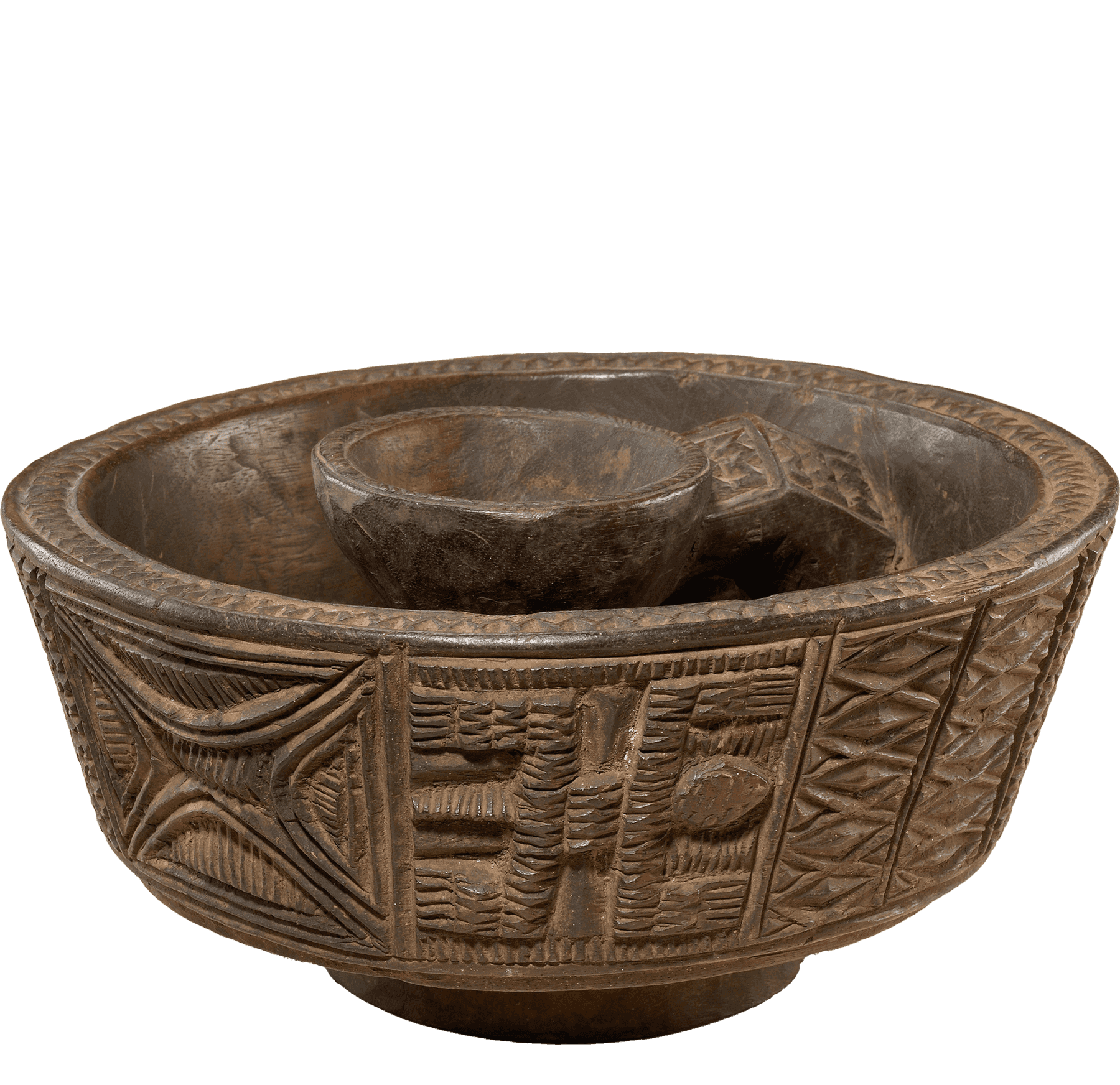 A dark wooden bowl carved with a geometric motifs and designs around the sides and edges of the bowl.