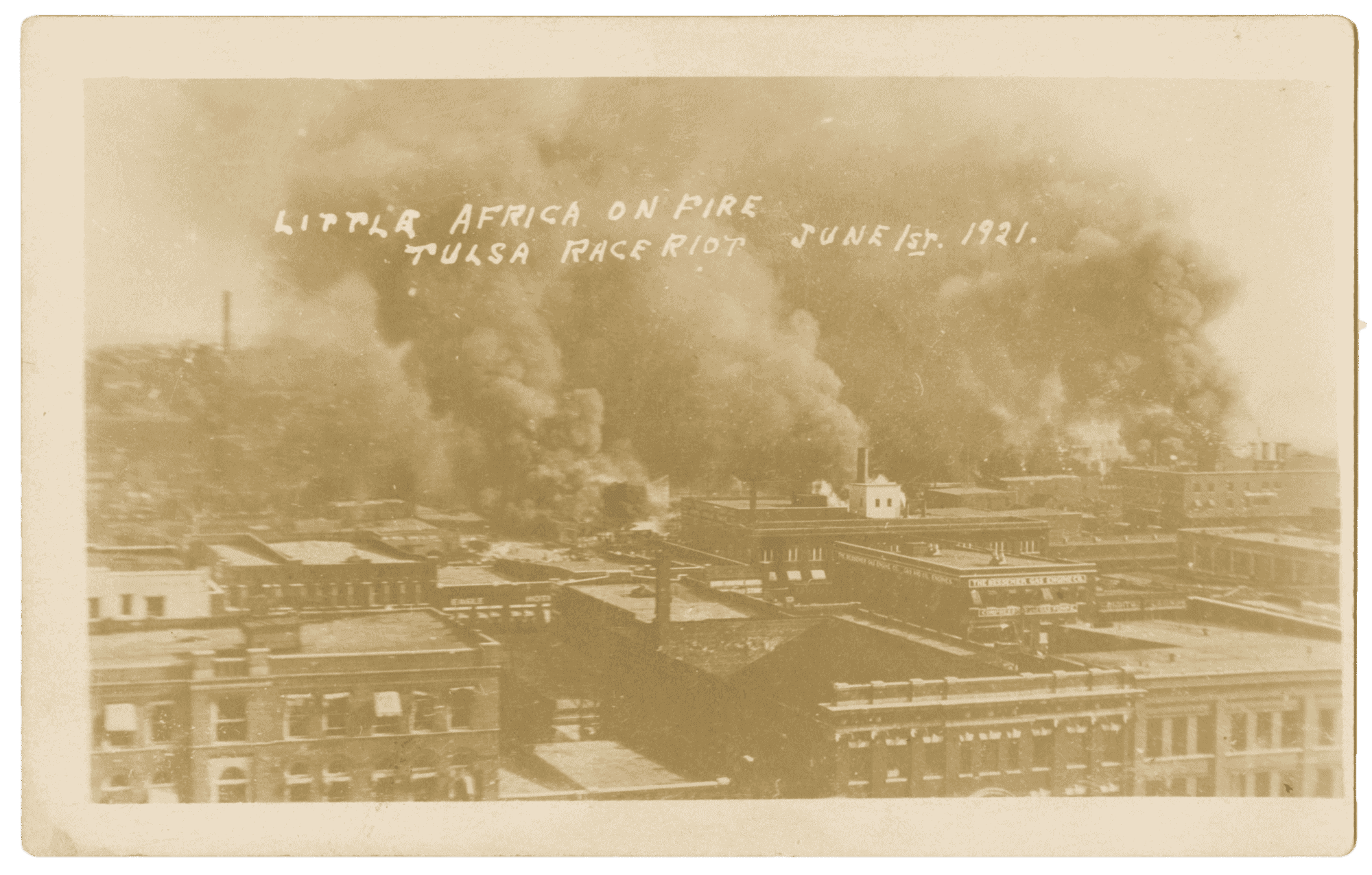 A sepia-toned photographic postcard depicting fires during the Tulsa Race Massacre.
