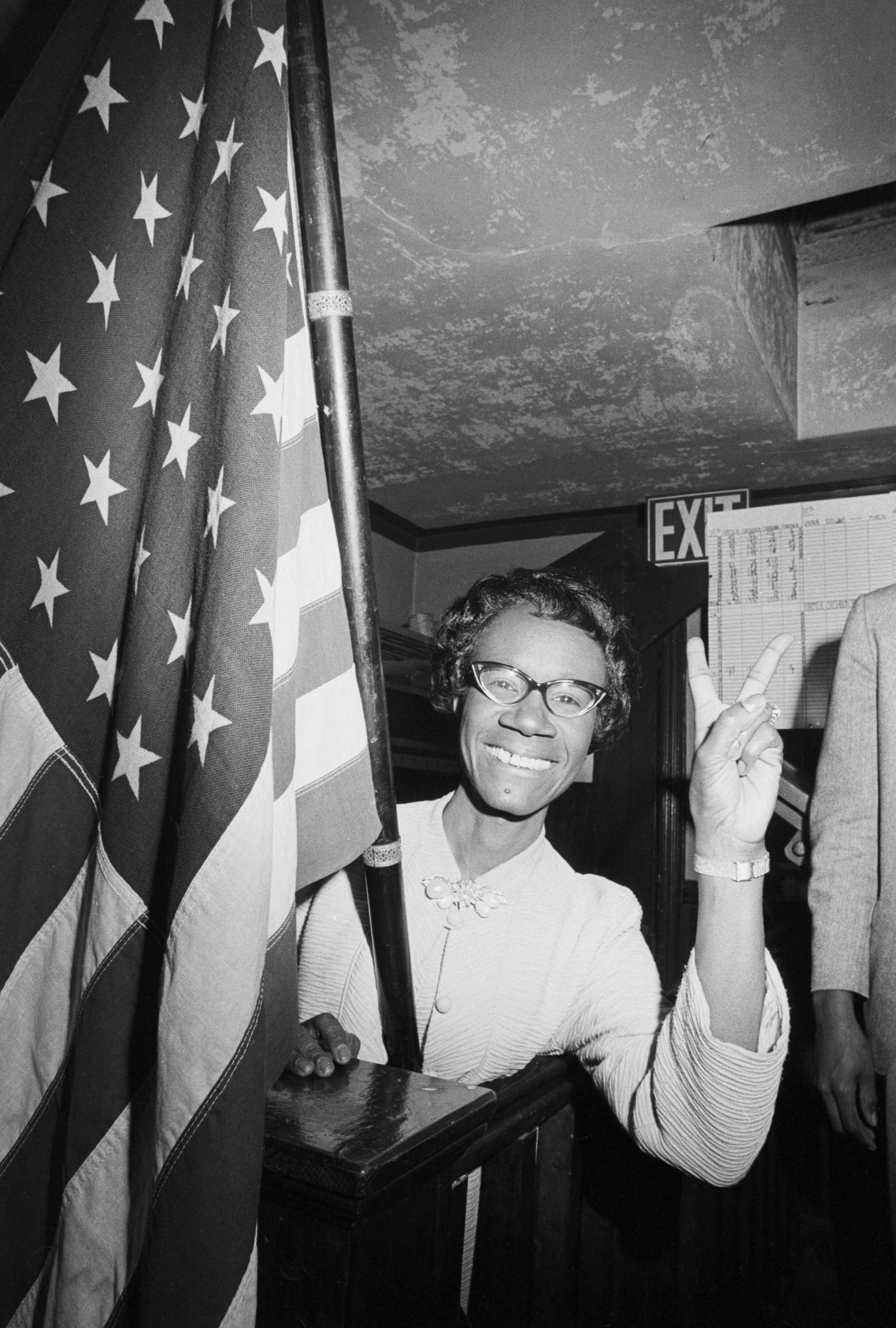 Photograph of Shirley Chisholm gives victory sign after winning election to Congress