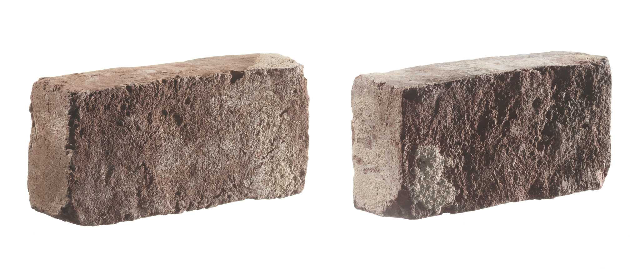 A red clay brick that was once part of the structure of the White House. The brick is a standard solid style brick, slightly uneven in shape. It is a reddish-brown color, and is covered with faint remnants of white-colored mortar on all sides. There are slight losses at two corners.