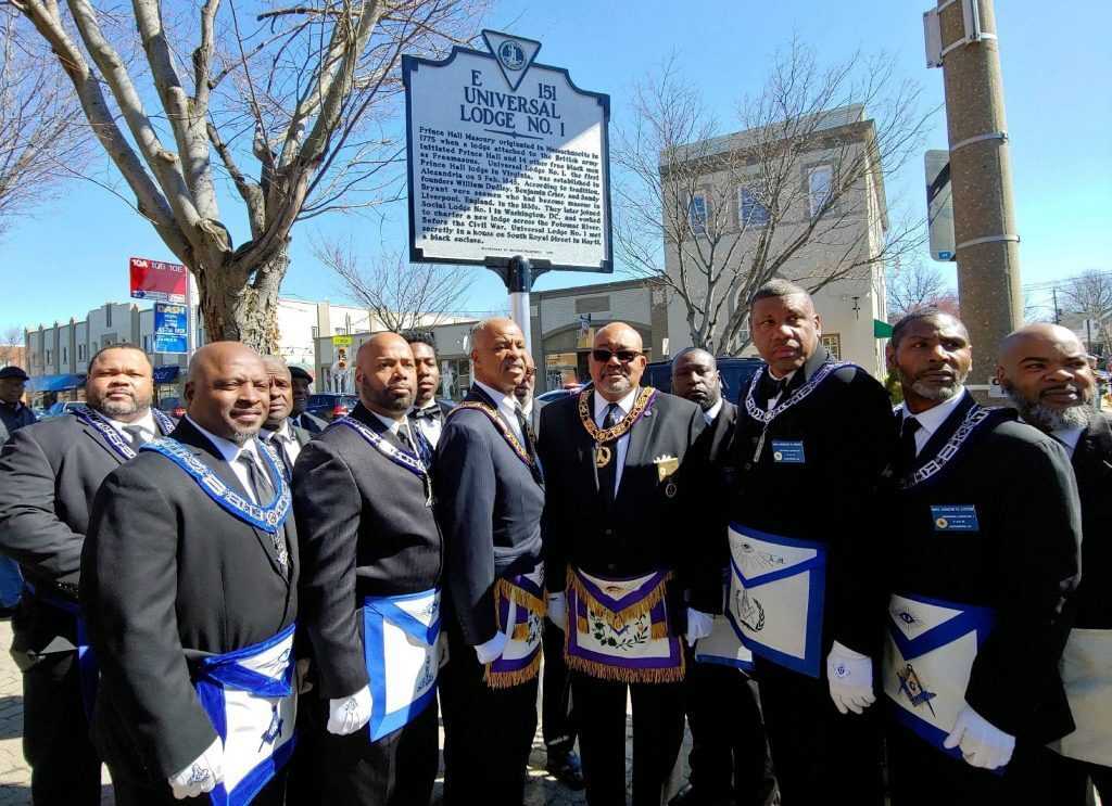 Photograph of Prince Hall Masons stand in front of a newly erected historic marker in Alexandria, Virginia