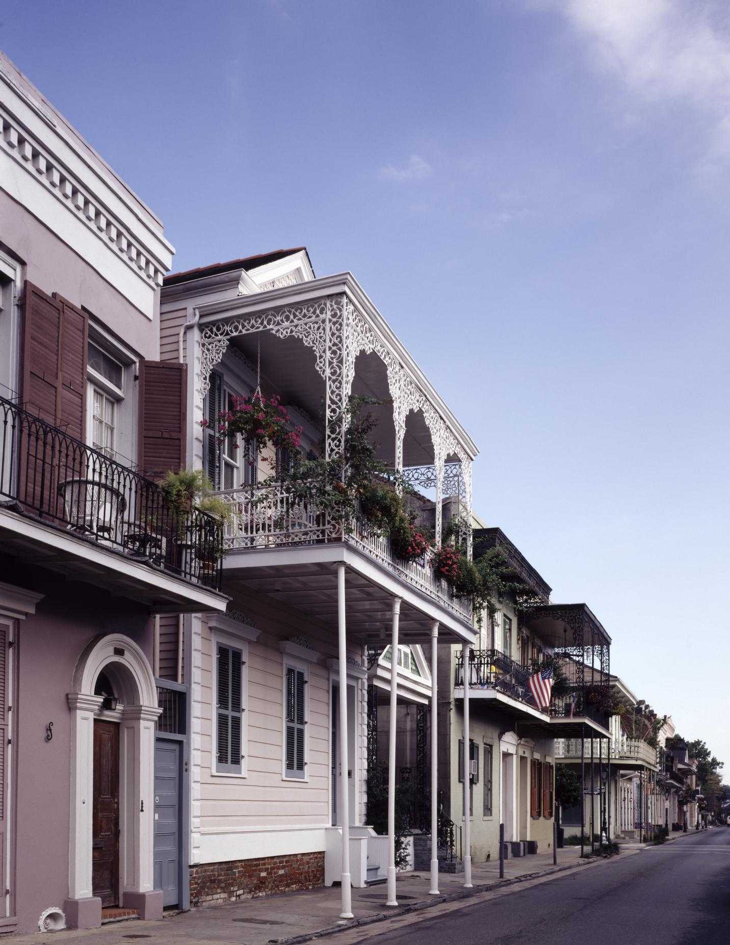 Color photograph of two story houses with balconies in the French Quarter of New Orleans.