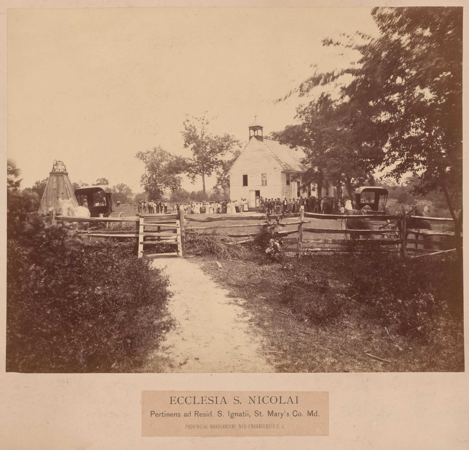 A sepia toned albumen print of the congregation, who are surrounded by the church in the distance.