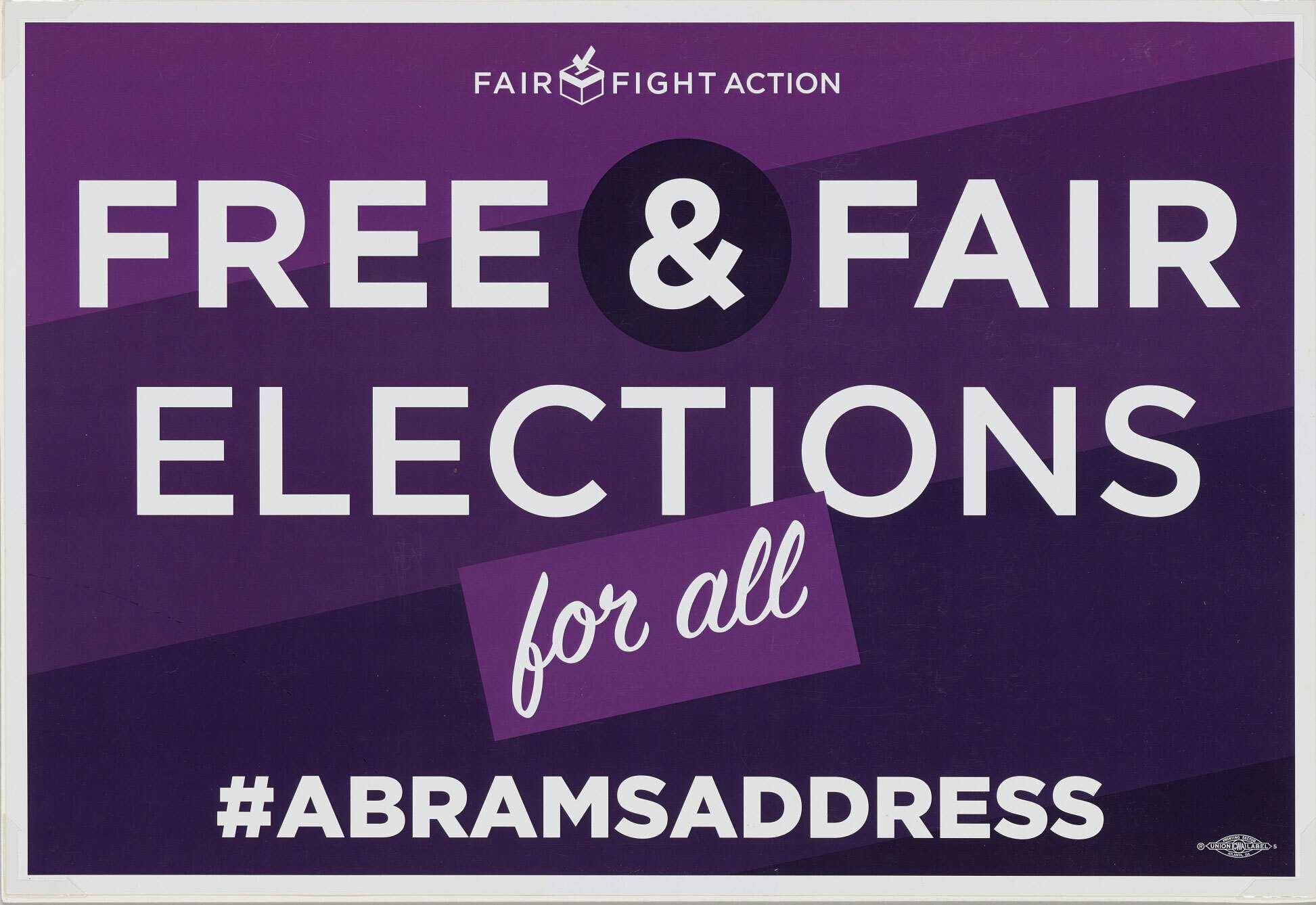 A purple and white double-print poster issued by Fair Fight Action organization. The rectangular poster has a gradient purple background with white text reading [FAIR FIGHT ACTION / FREE & FAIR / ELECTIONS / for all / #ABRAMSADDRESS].