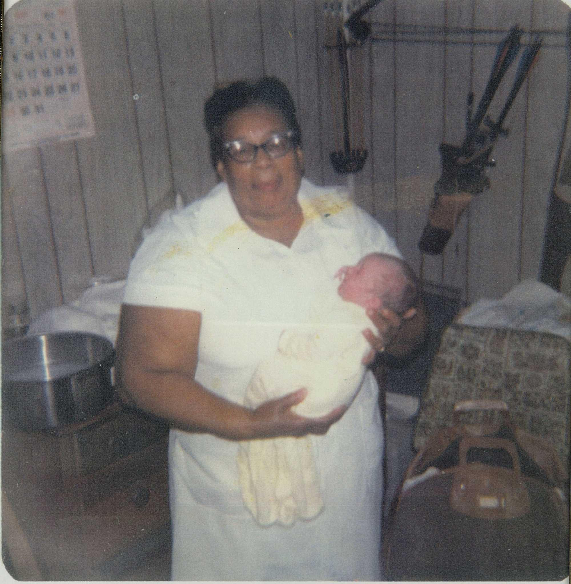 Photograph of Midwife Amanda Carey Carter holding an infant