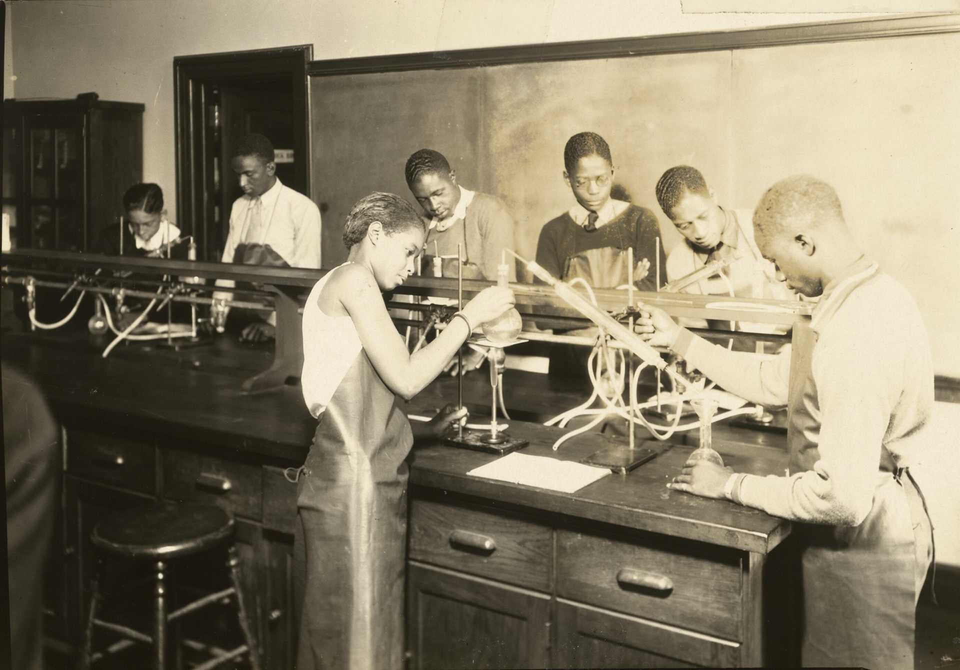 A gelatin silver print of students working in a science lab at the Manual Training and Industrial School for Colored Youth in Bordentown, New Jersey.