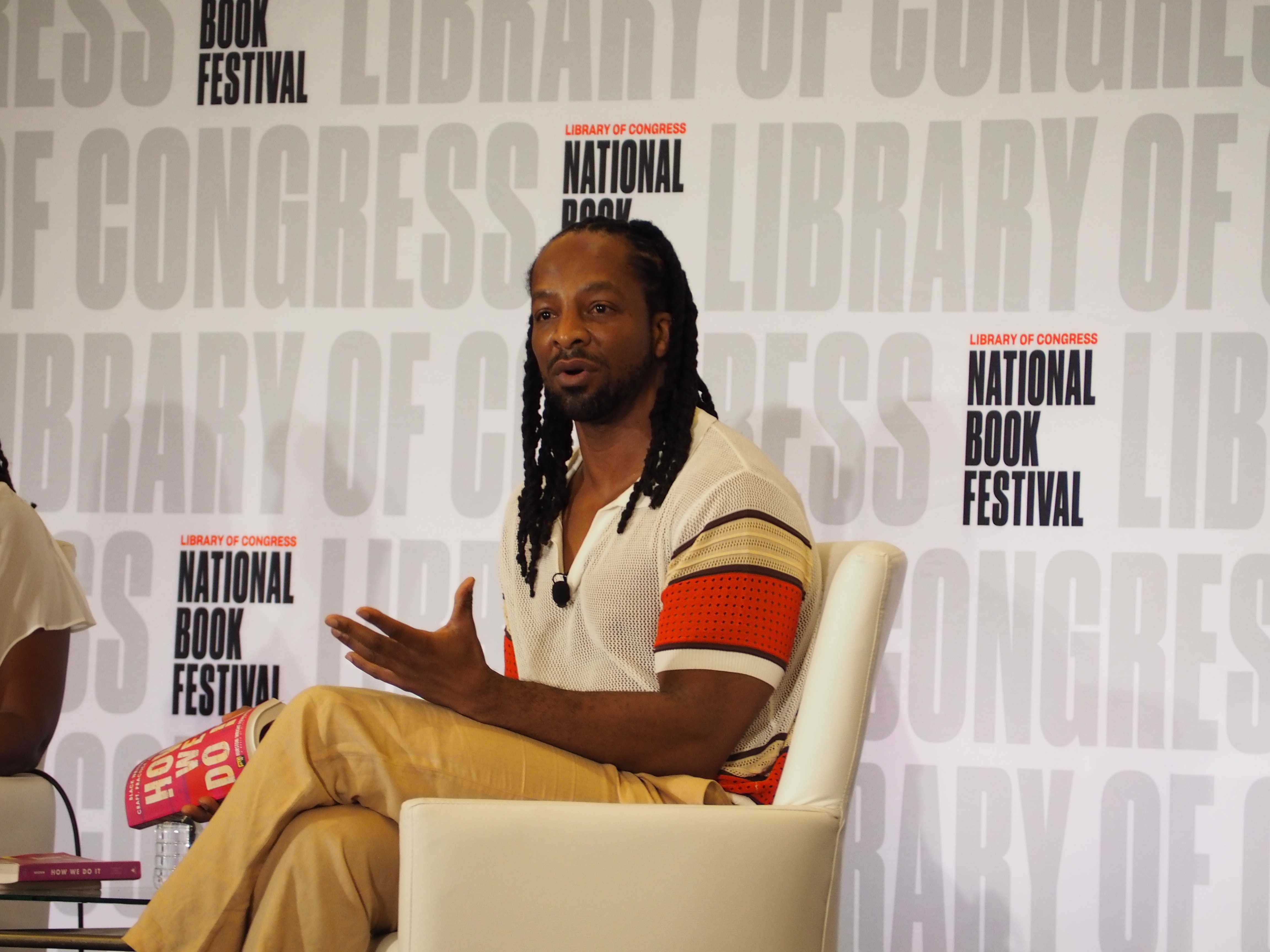 Color photograph of author Jericho Brown seated on stage at the National Book Festival.