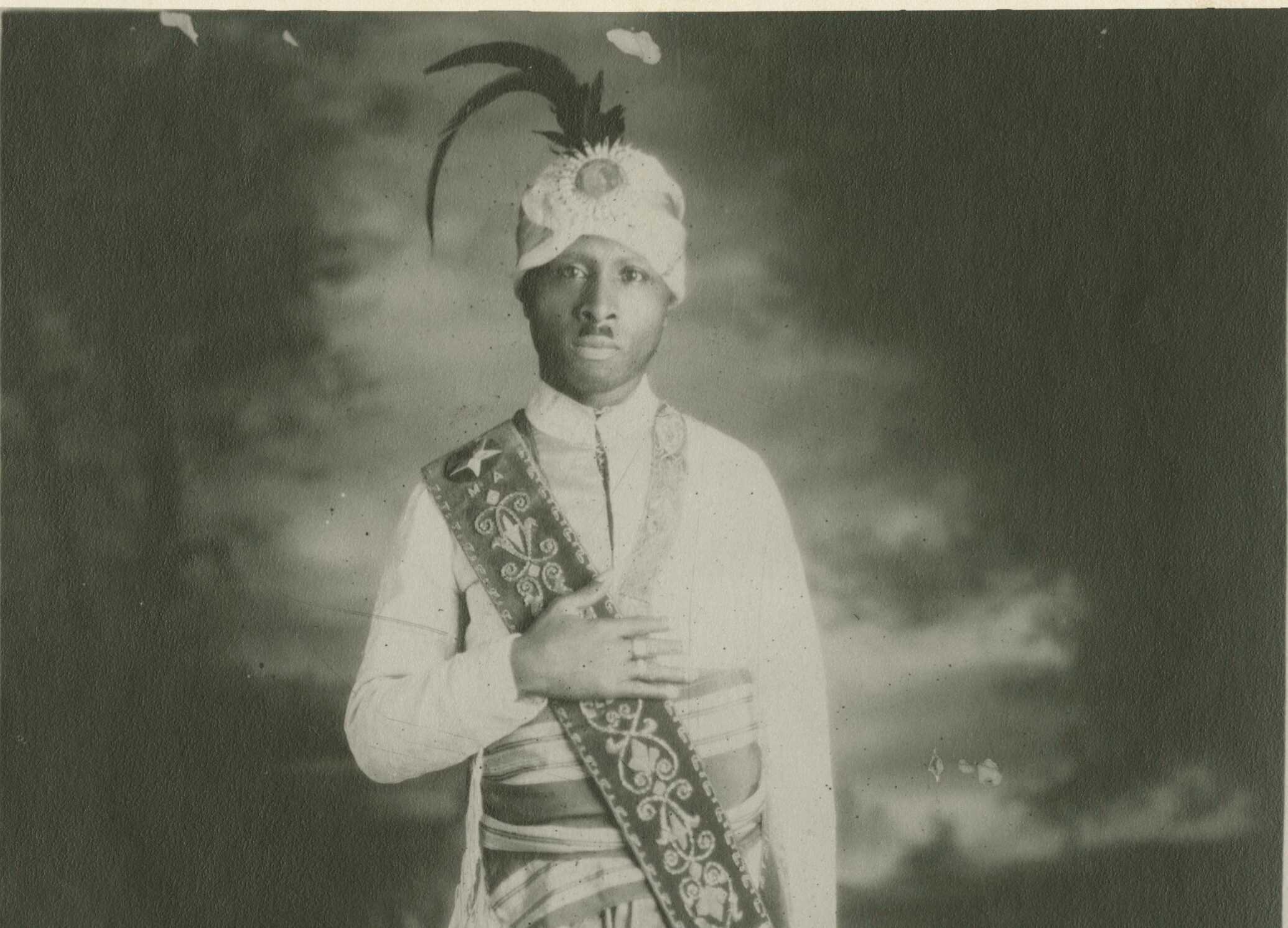 Gelatin silver print full-length portrait of Prophet Noble Drew Ali, founder of the Moorish Science Temple of America.