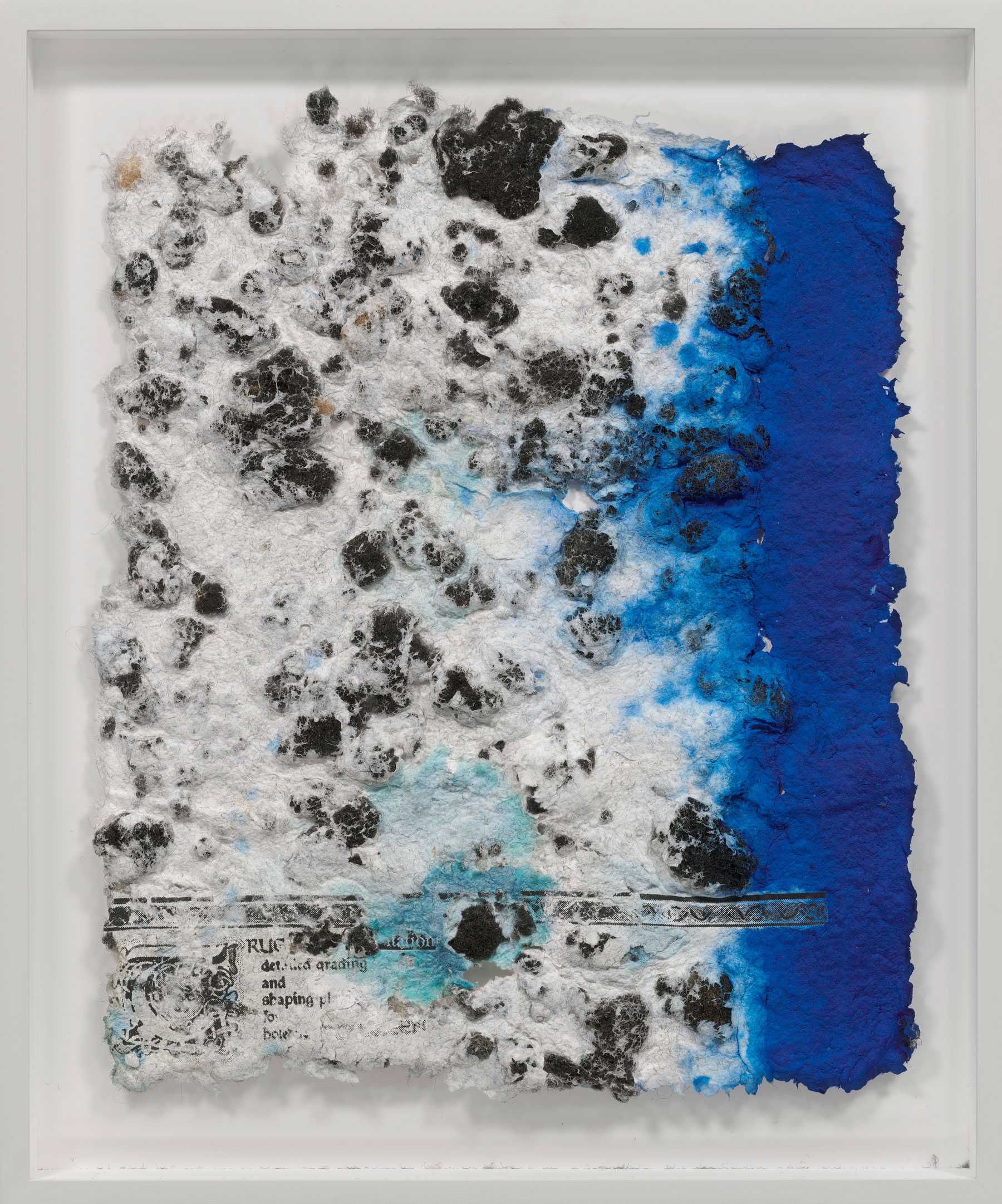 Abstract artwork with textured black and white surface transitioning to vibrant blue on the right, resembling a blend of ink and paper pulp.