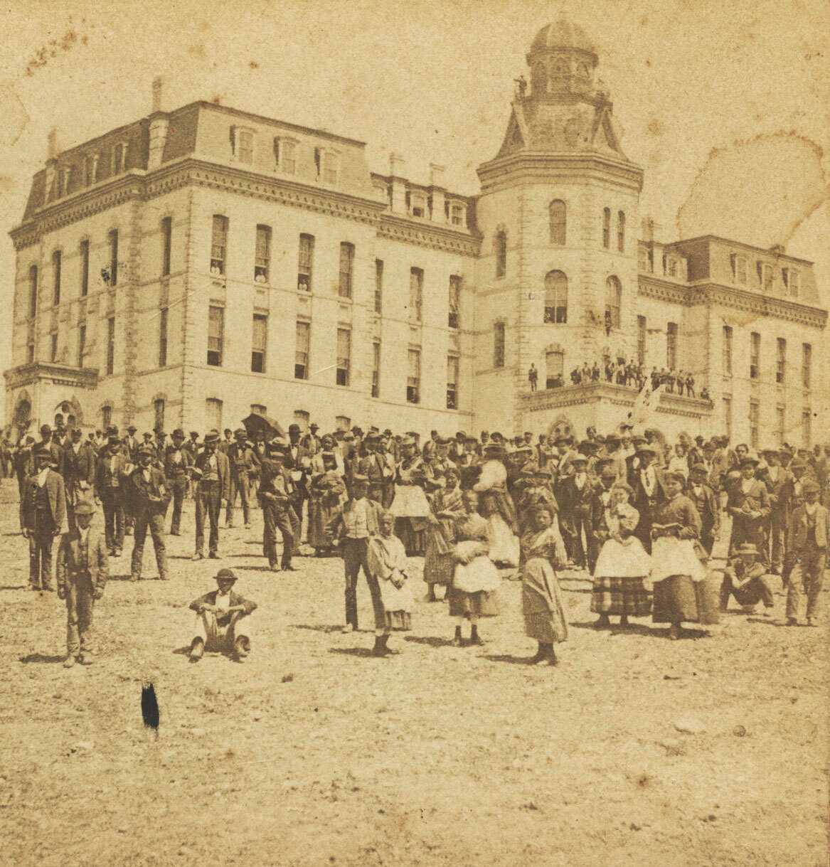 A sterograph produced by C. W. Woodward of people outside the Main Building housed the university’s administrative offices and served as the Freedmen’s Bureau headquarters.