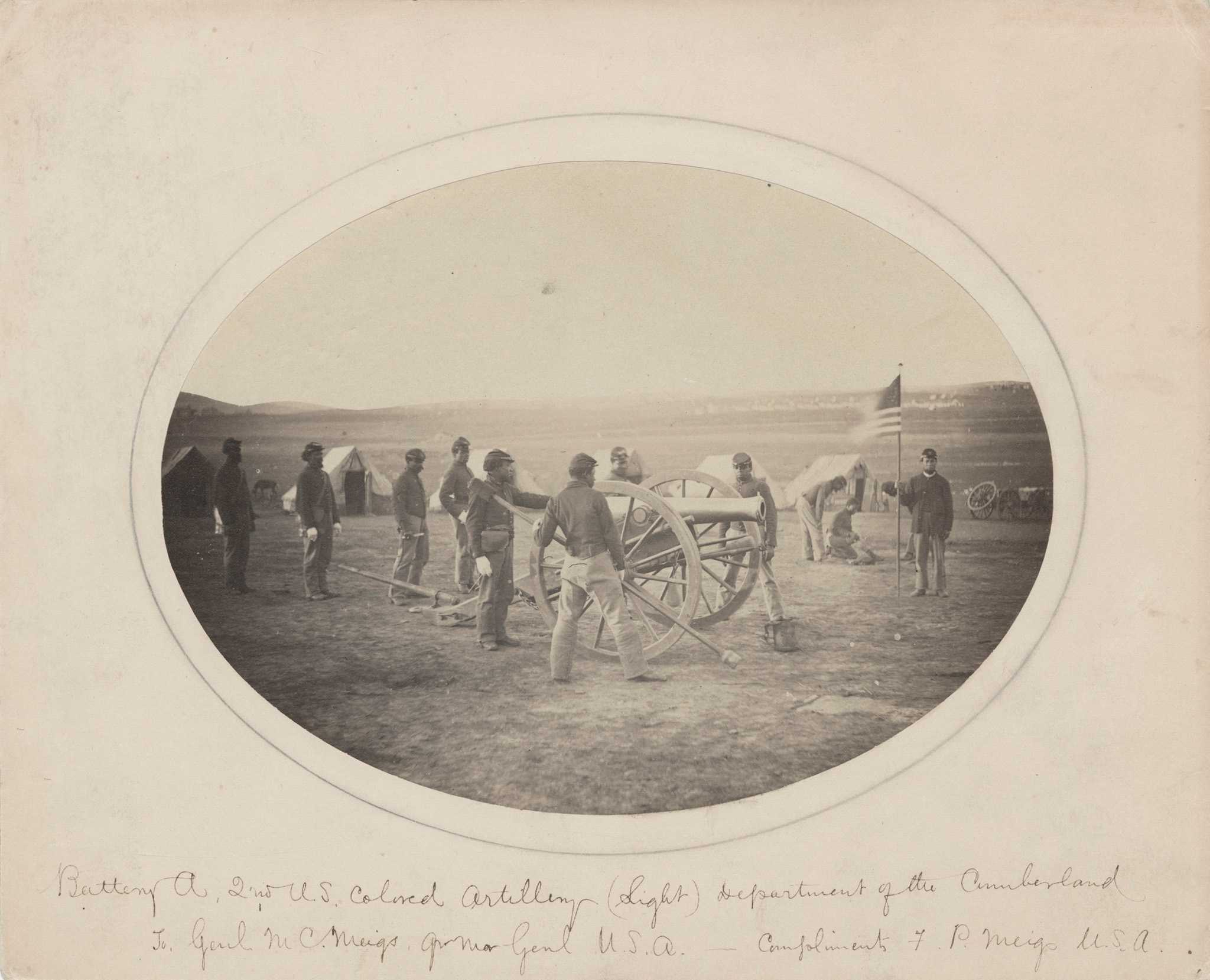 Photograph of U.S. Colored Troops next to a cannon