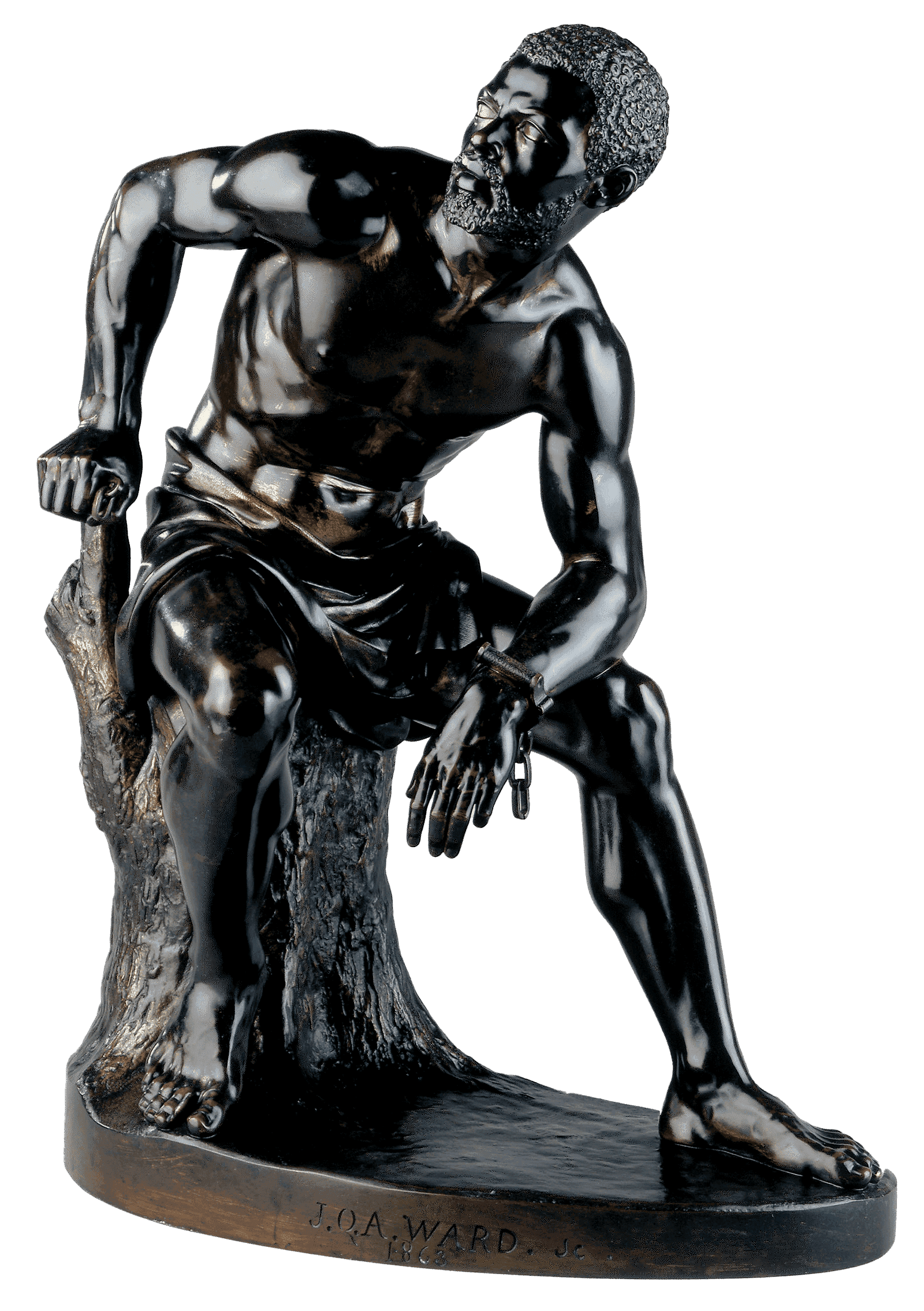 A bronze statue of an shirtless African American man sitting on a stump. On his left wrist is a single handcuff, the chain dangling down.