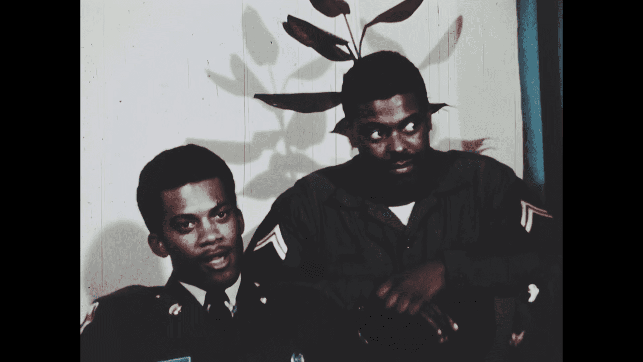 Two African American military personnel sitting side by side