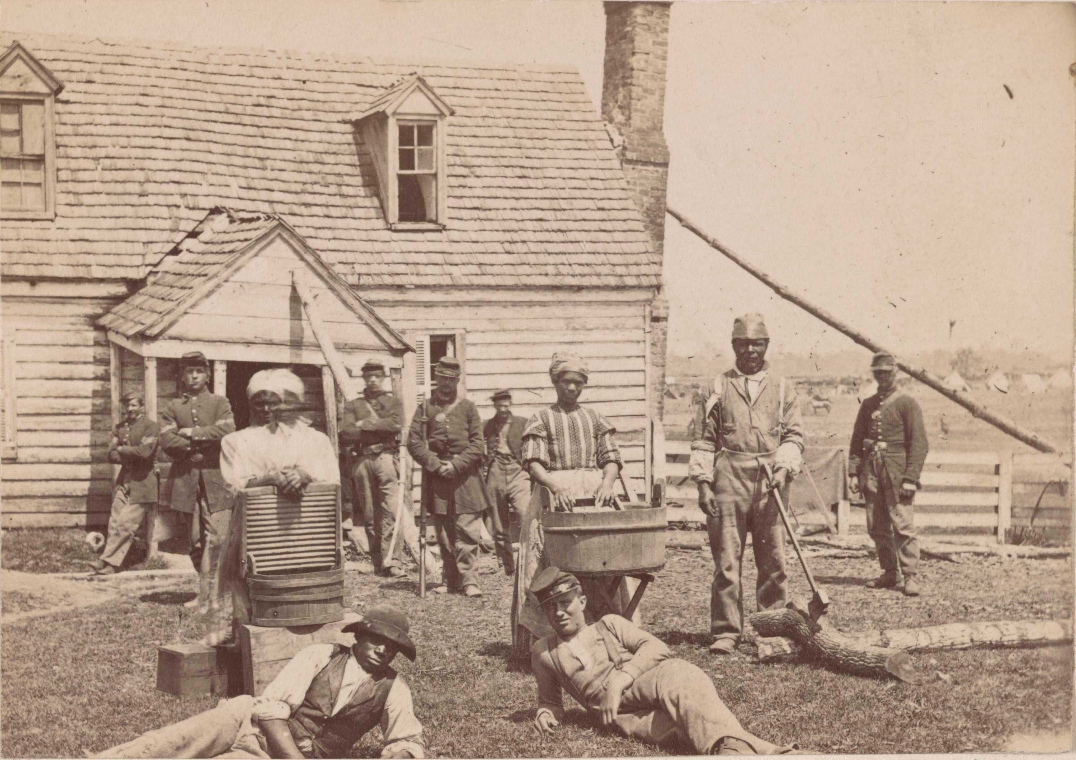 Photograph of enlisted Black soldiers in front of farm house