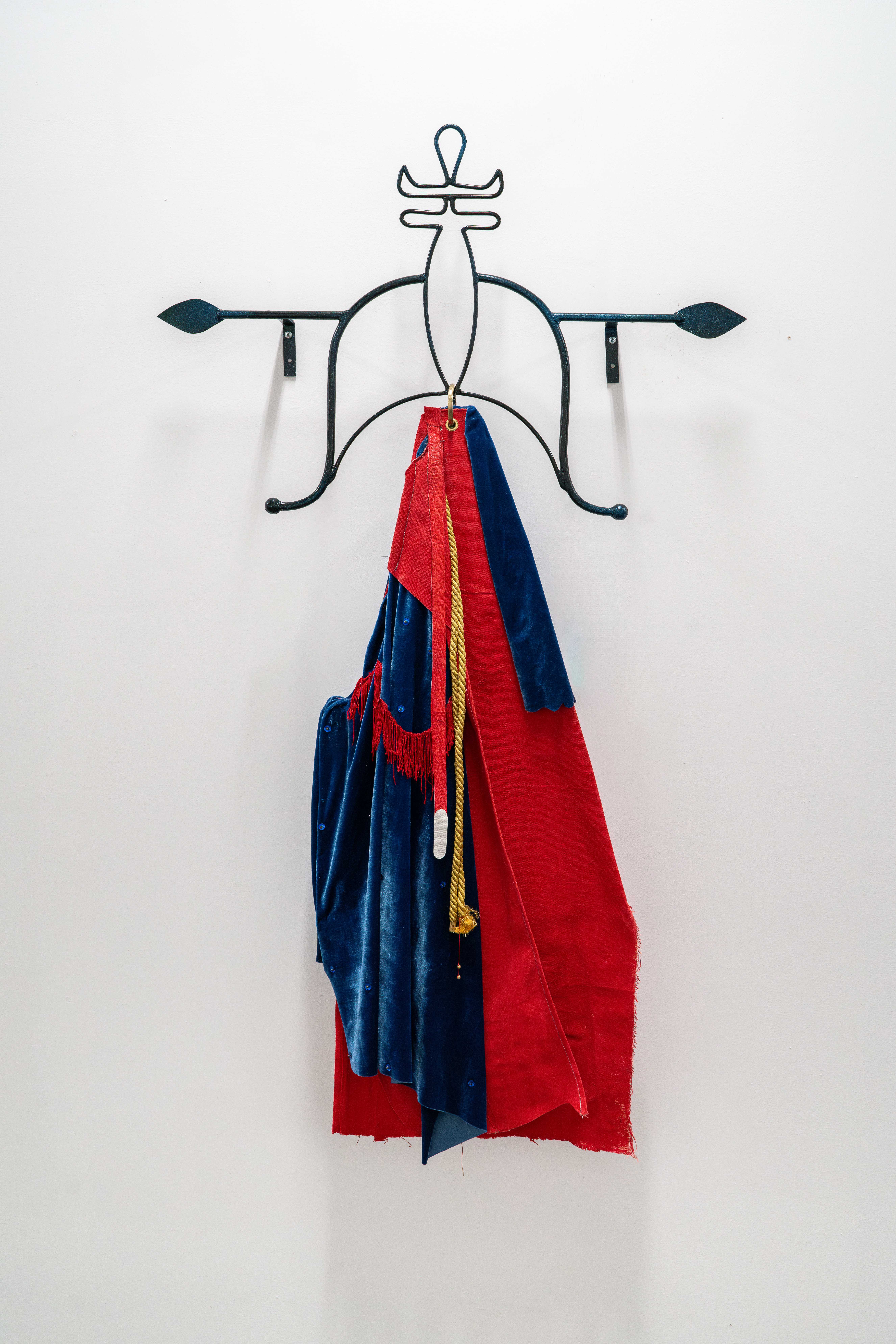Blue and red flag hanging from a decorative black rod.