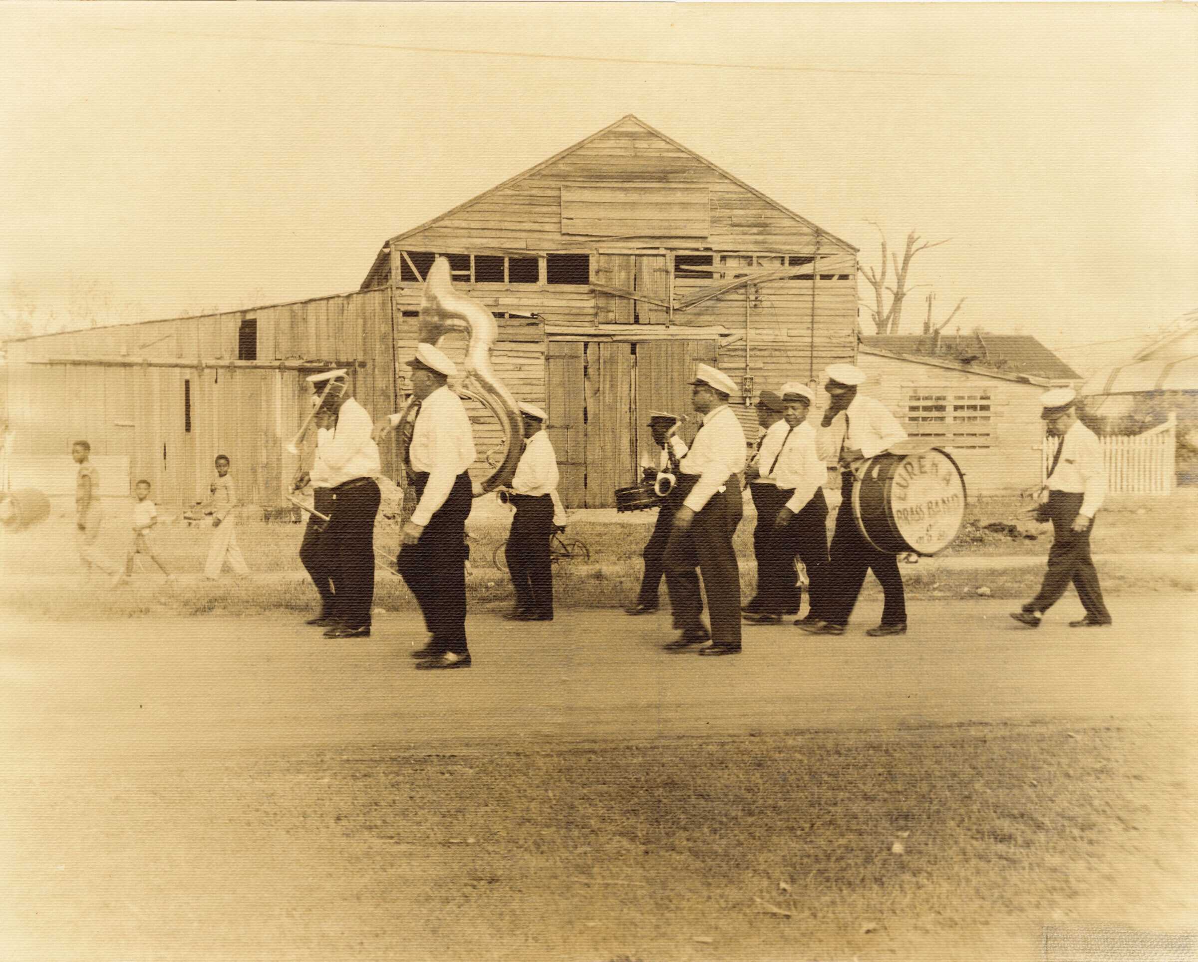 Sepia toned photograph of men in marching band.