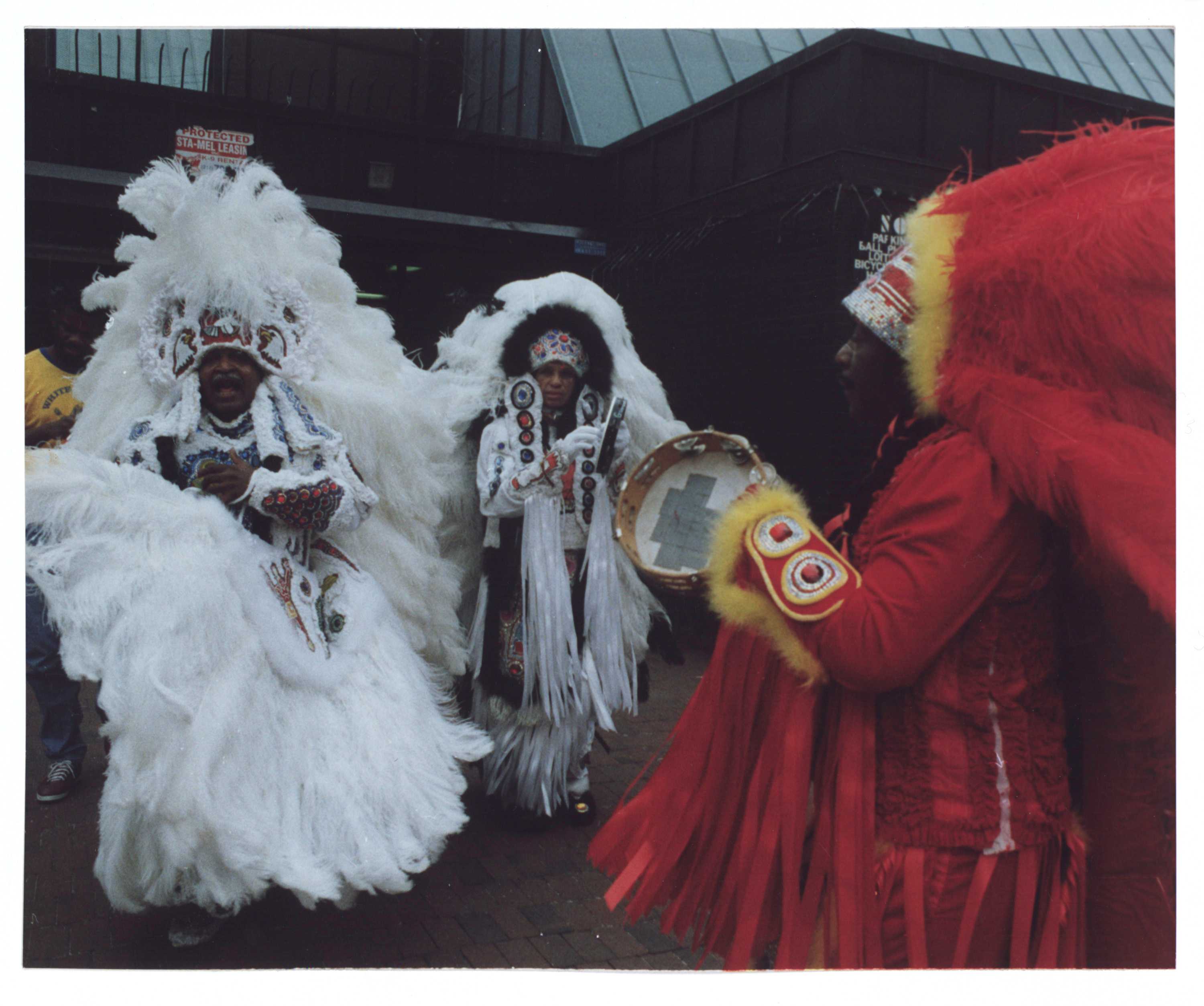 Three members of the White Eagles Indian Mardi Gras tribe celebrating.