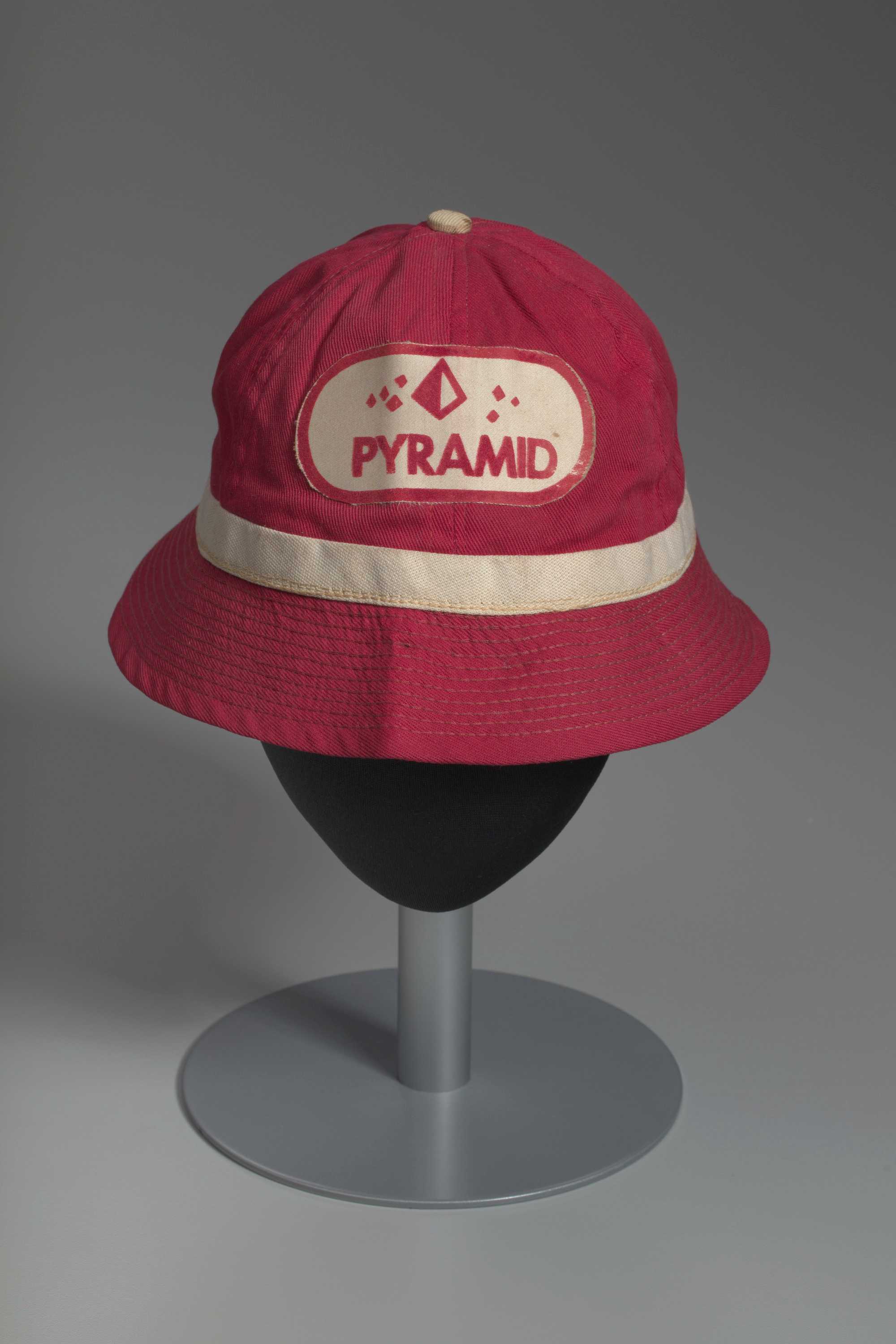 A red, canvas, pledge bucket hat with an off-white band around the base of the crown from Delta Sigma Theta sorority.