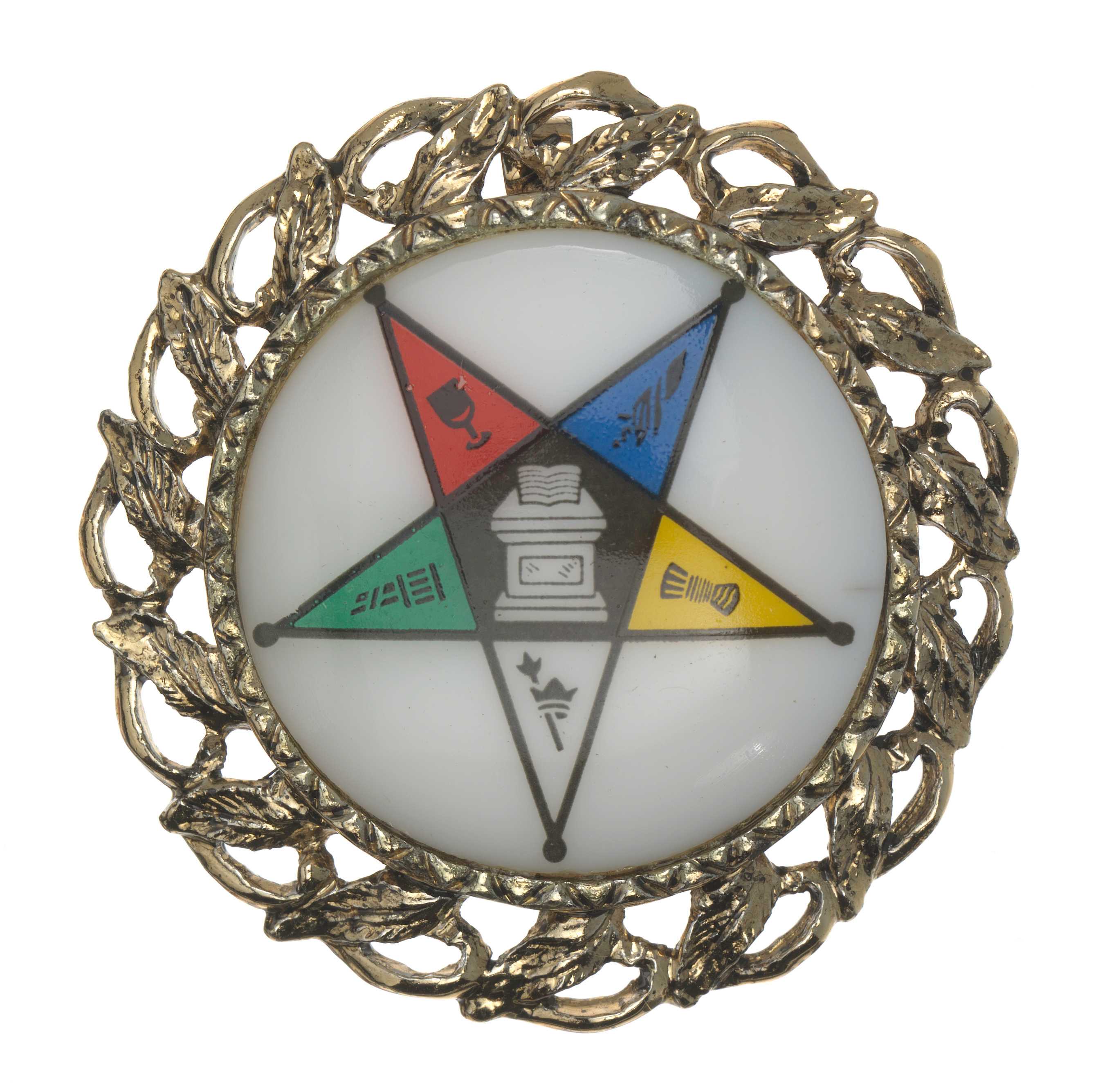 A circular metal pendant with a ceramic center.